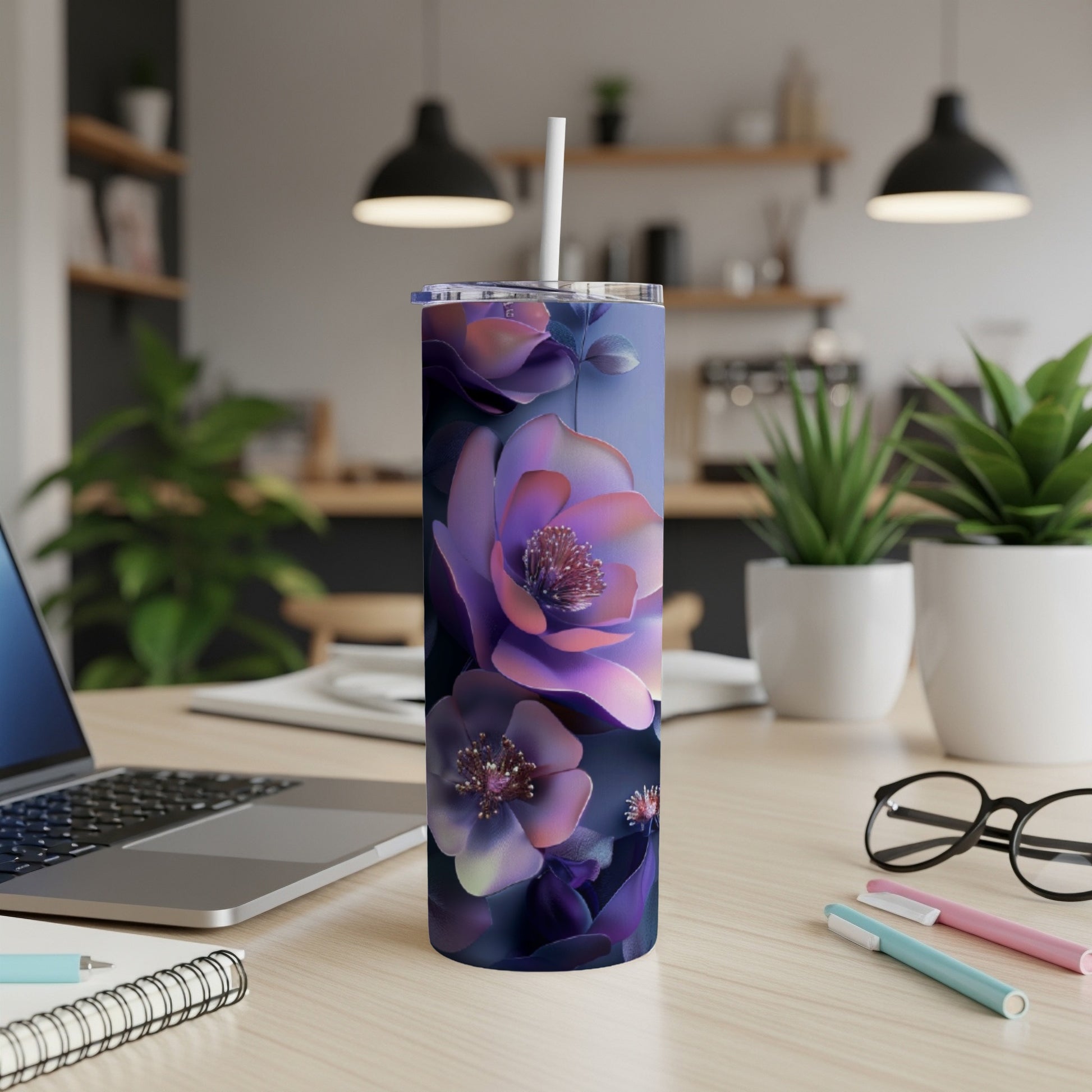 Purple floral tumbler with a white straw on a desk.