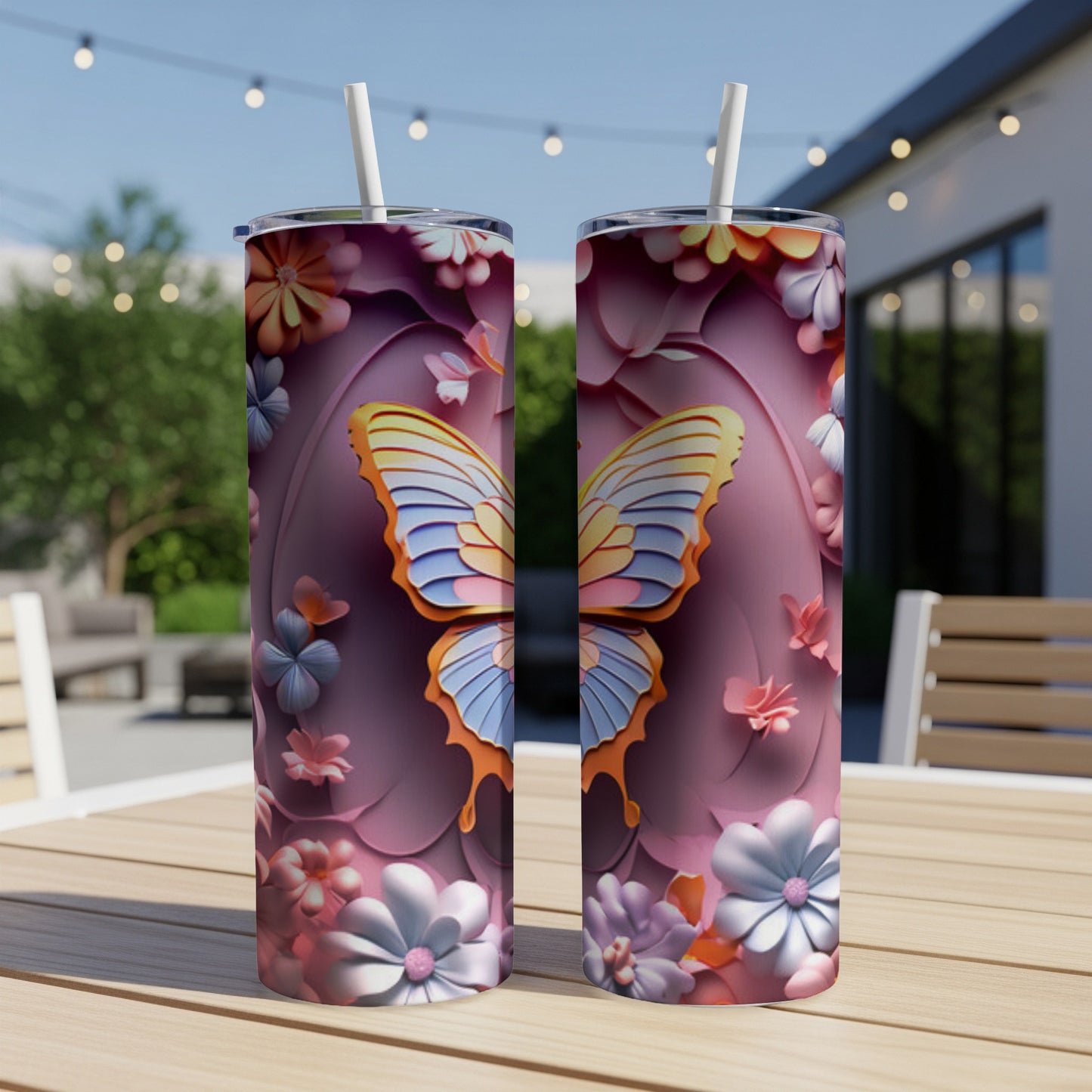 Two tumblers with butterfly and floral pattern on outdoor table.