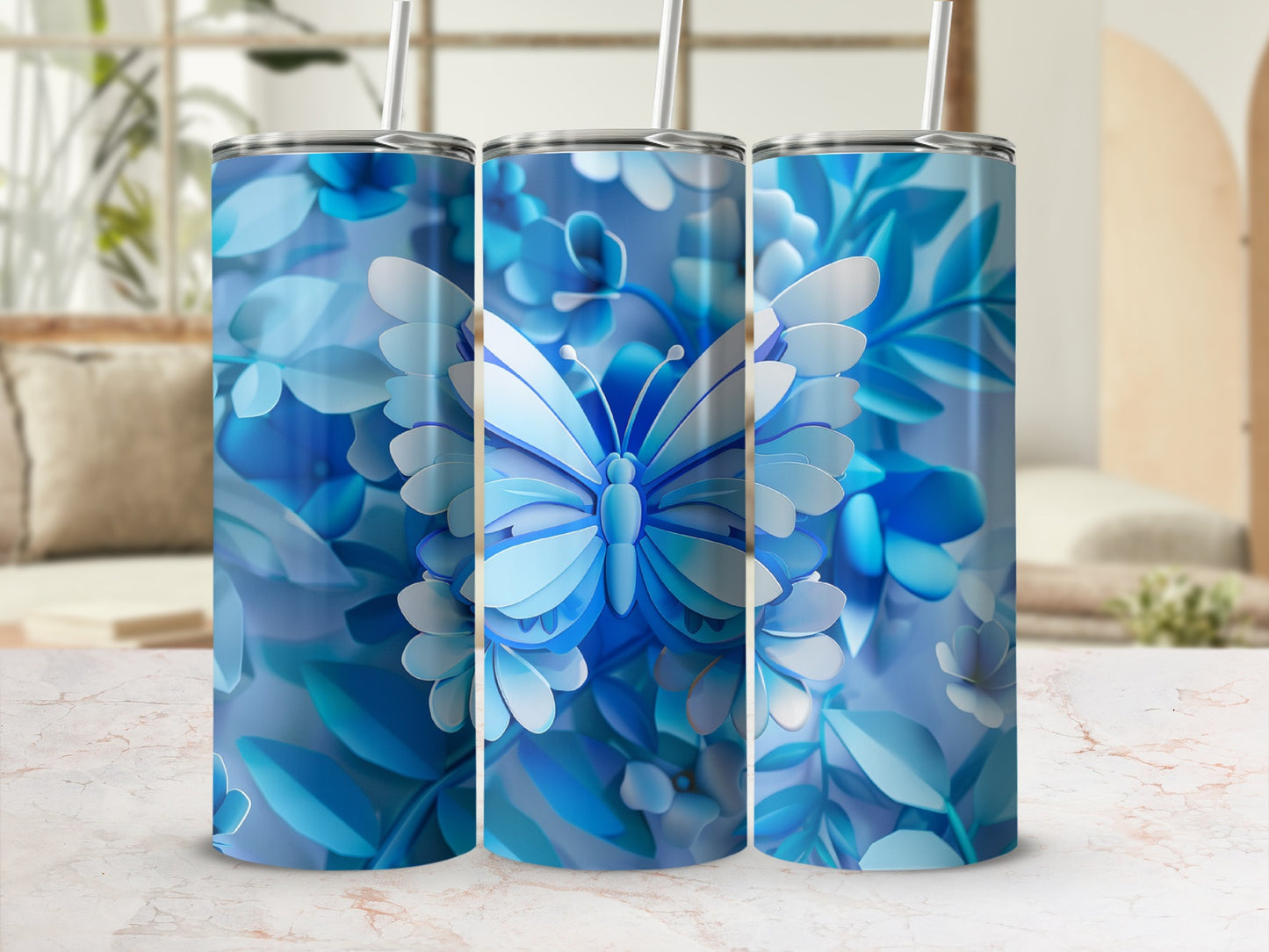 Blue butterfly and floral design on three tumblers with straws.