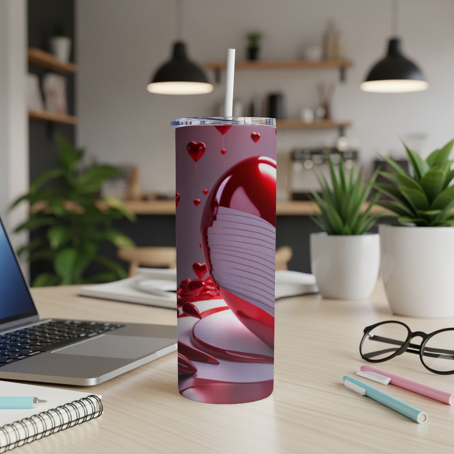 Red Valentine's Day heart tumbler with a face mask on a desk.