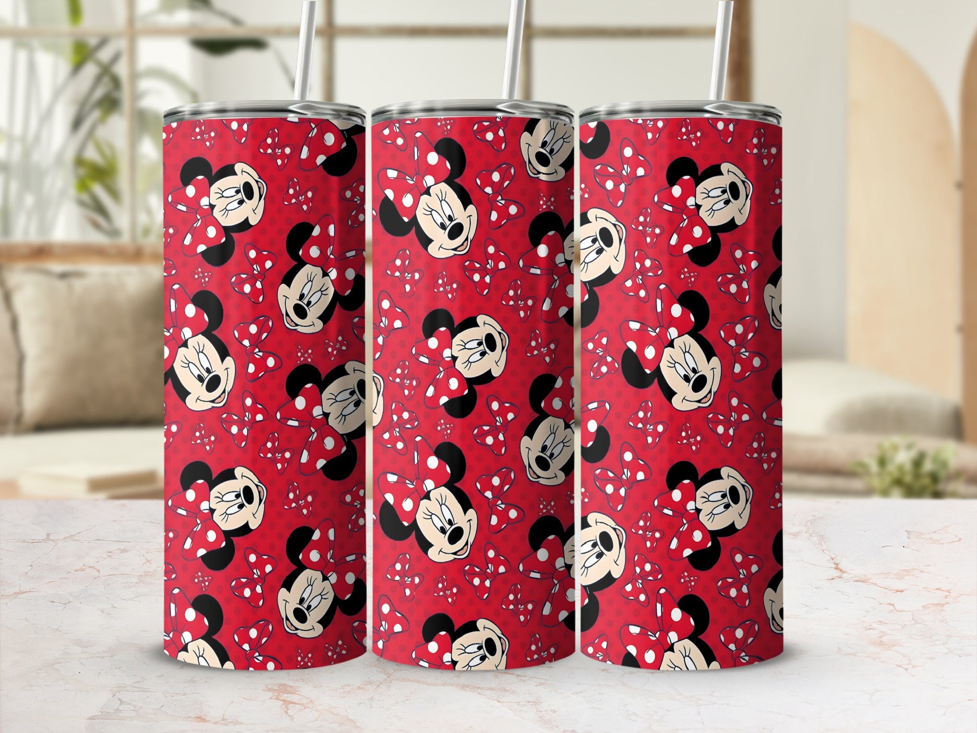 Red tumbler with repeating pattern of Minnie Mouse and white polka dots.