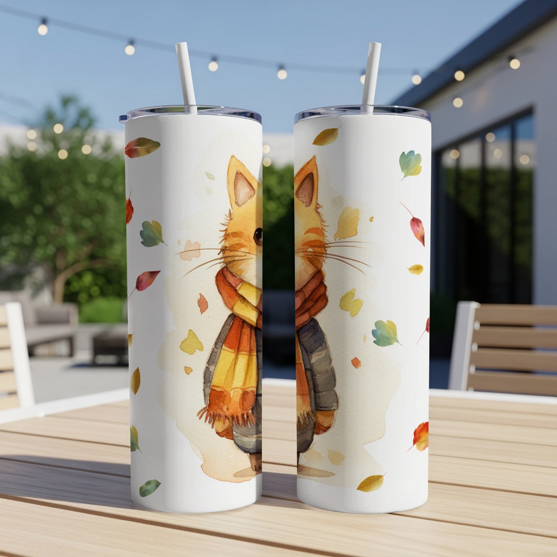 Two tall tumblers with a watercolor cat illustration and falling leaves.