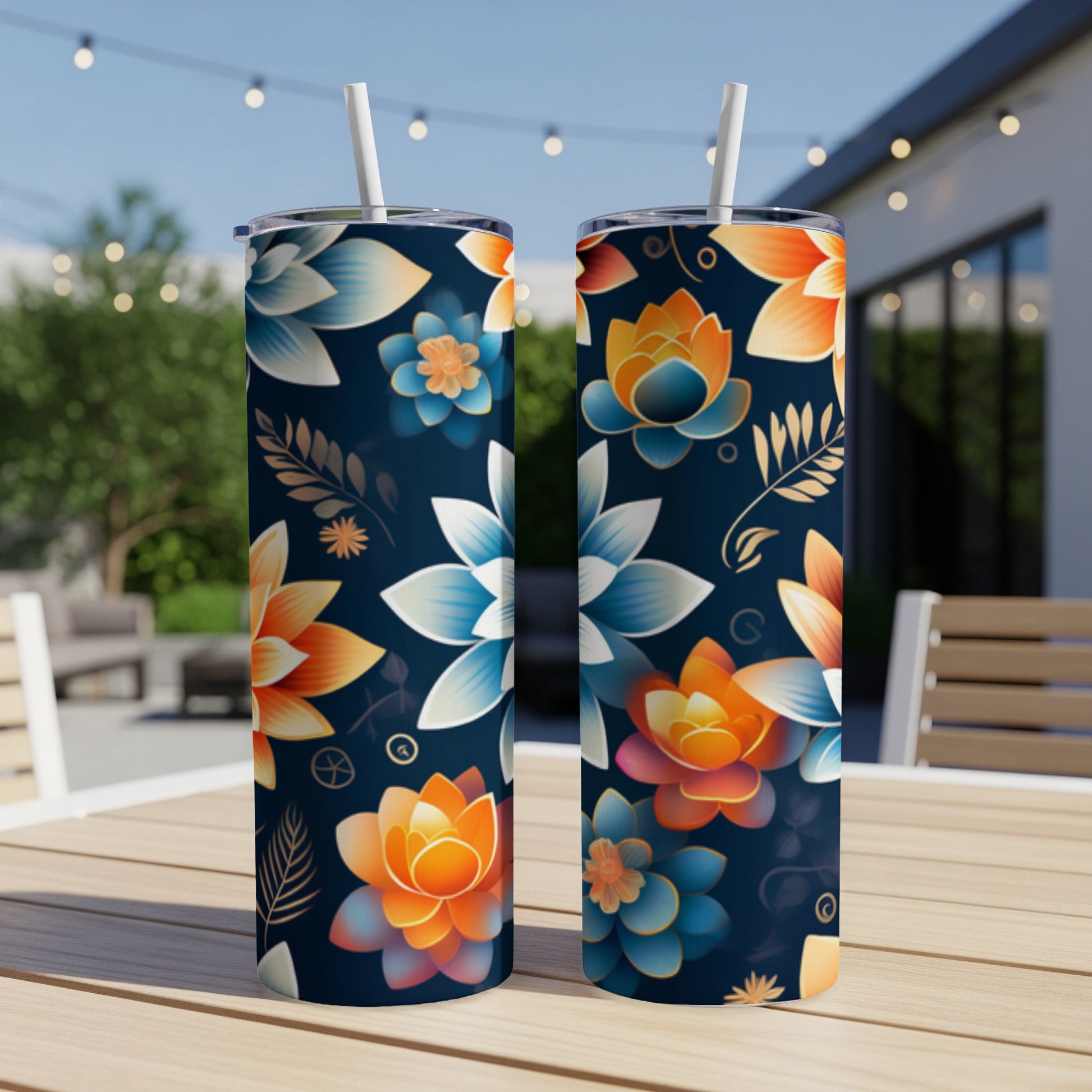 Two navy tumblers with colorful floral patterns sit on a wooden table.