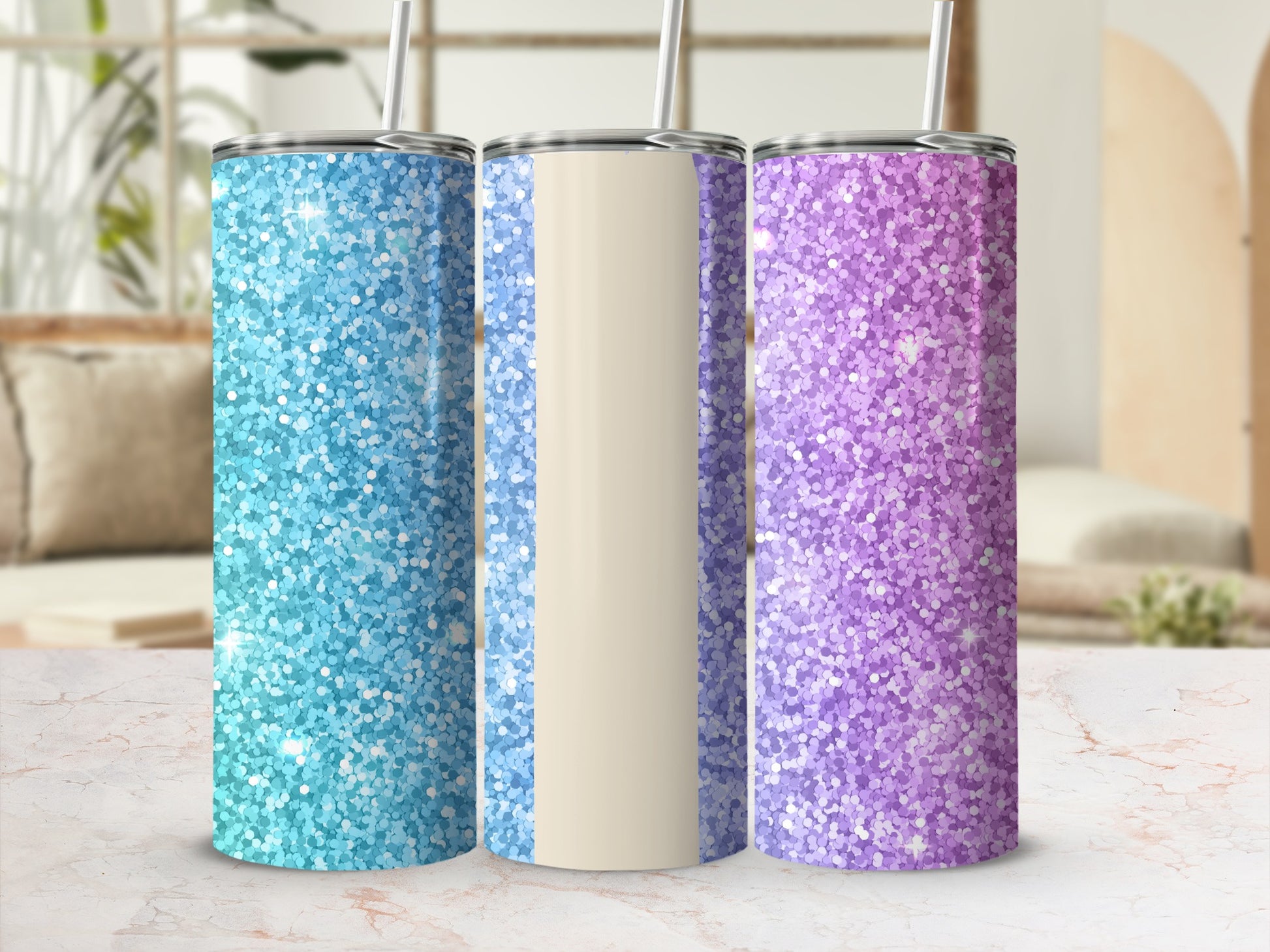 Three glitter tumblers: blue, beige, and purple, with straws, on a marble surface.