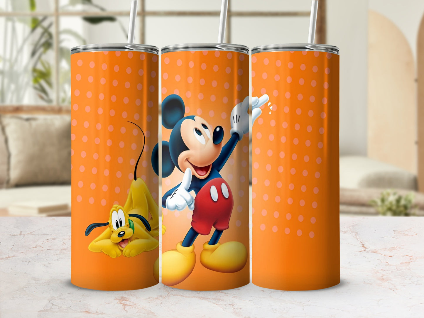 Three tumblers with Mickey Mouse and Pluto on an orange polka dot background.