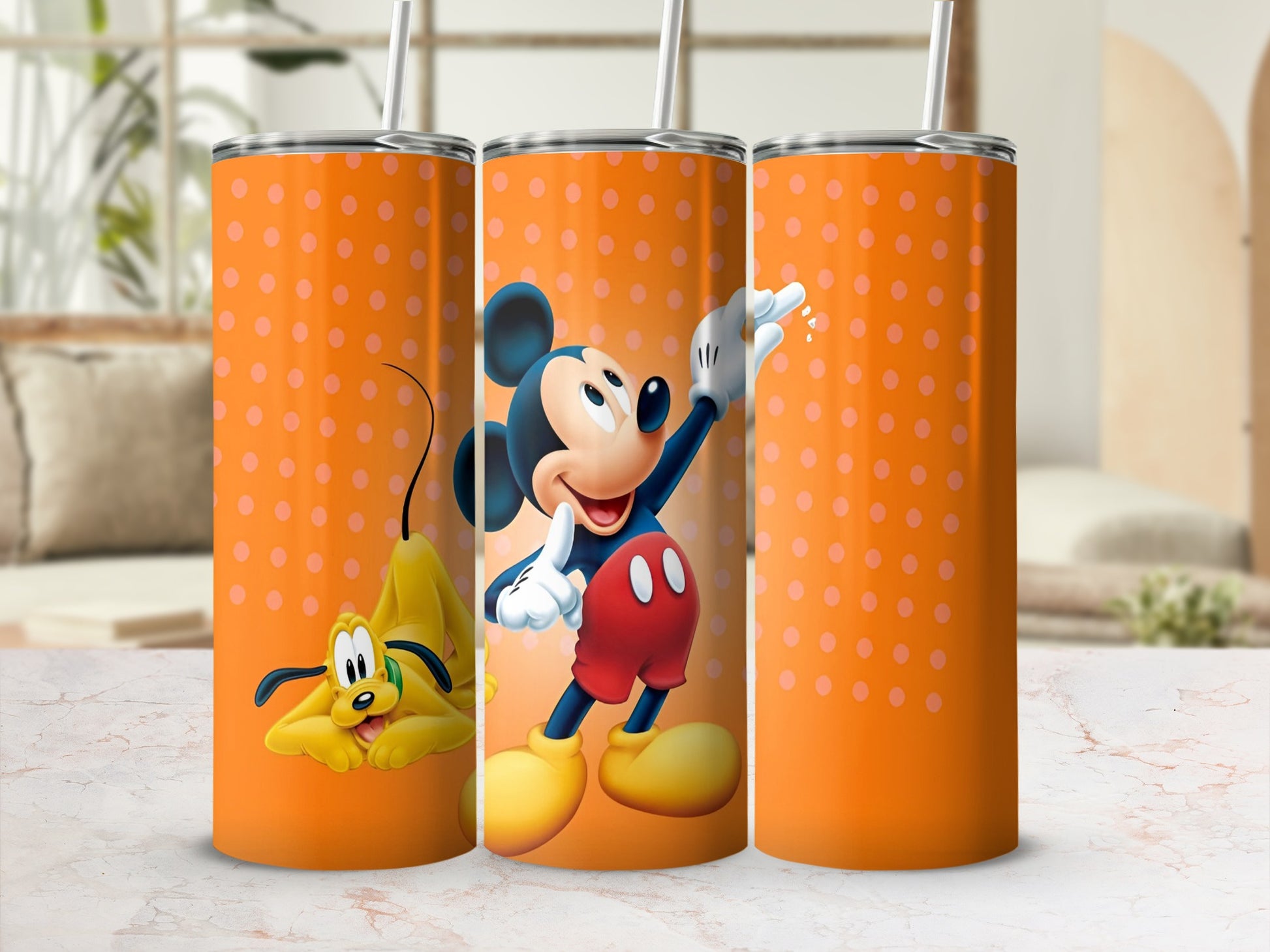 Three tumblers with Mickey Mouse and Pluto on an orange polka dot background.