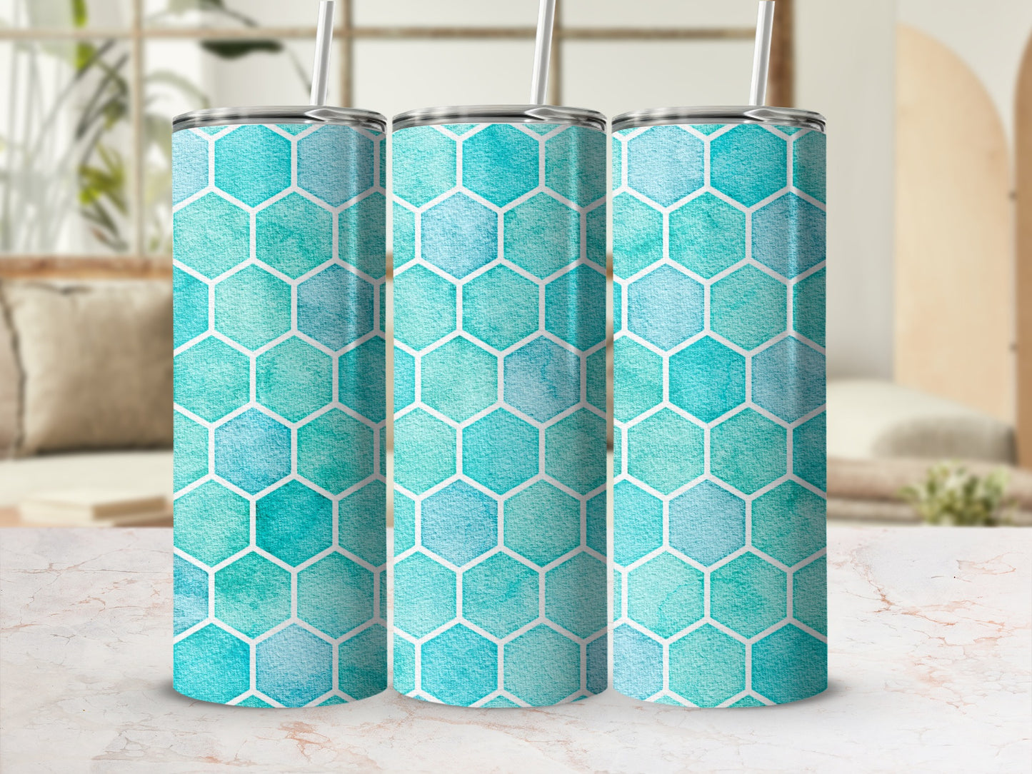 Three tumblers with turquoise watercolor hexagon pattern and white straws.