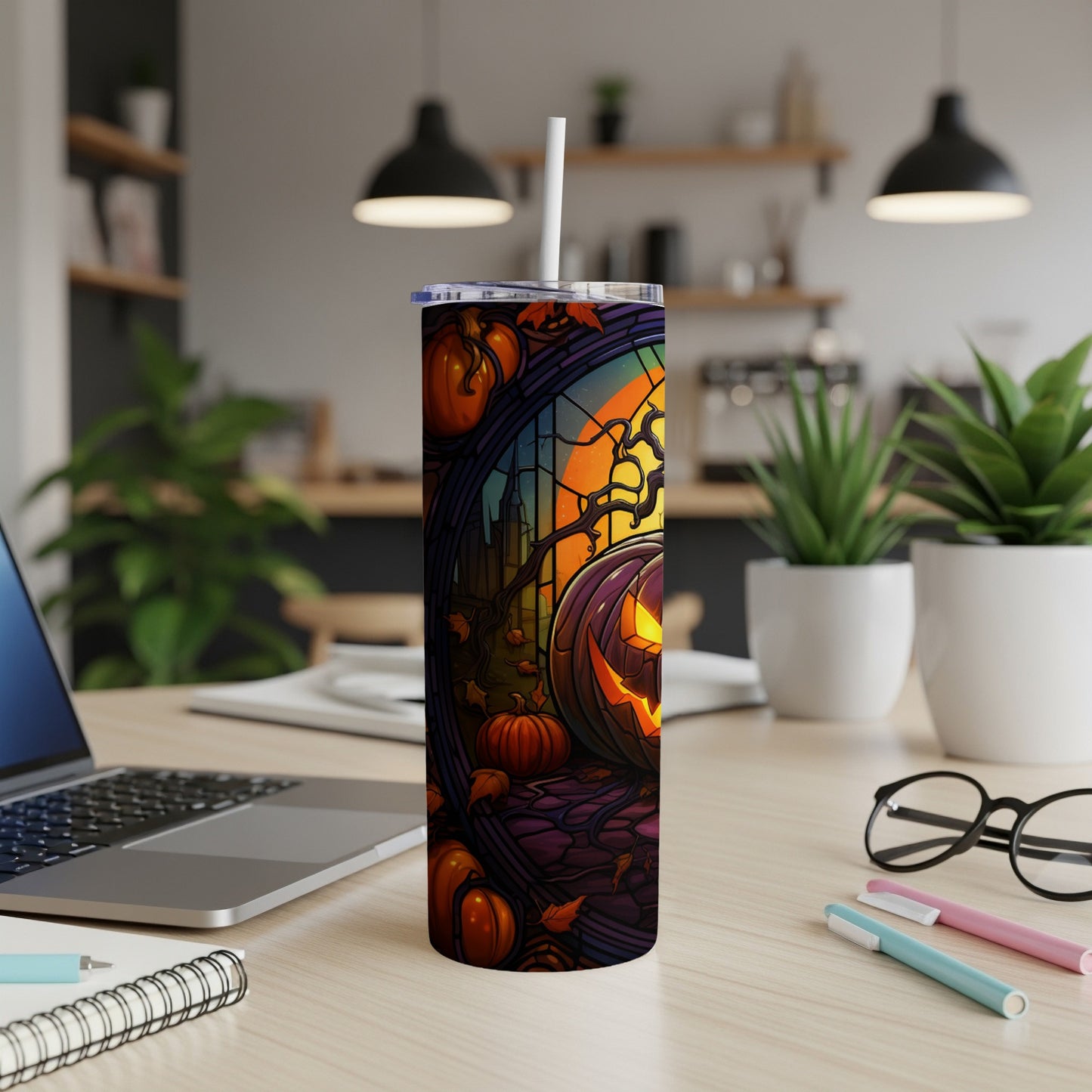 Halloween tumbler with jack-o'-lantern, pumpkins, and spooky tree at sunset.