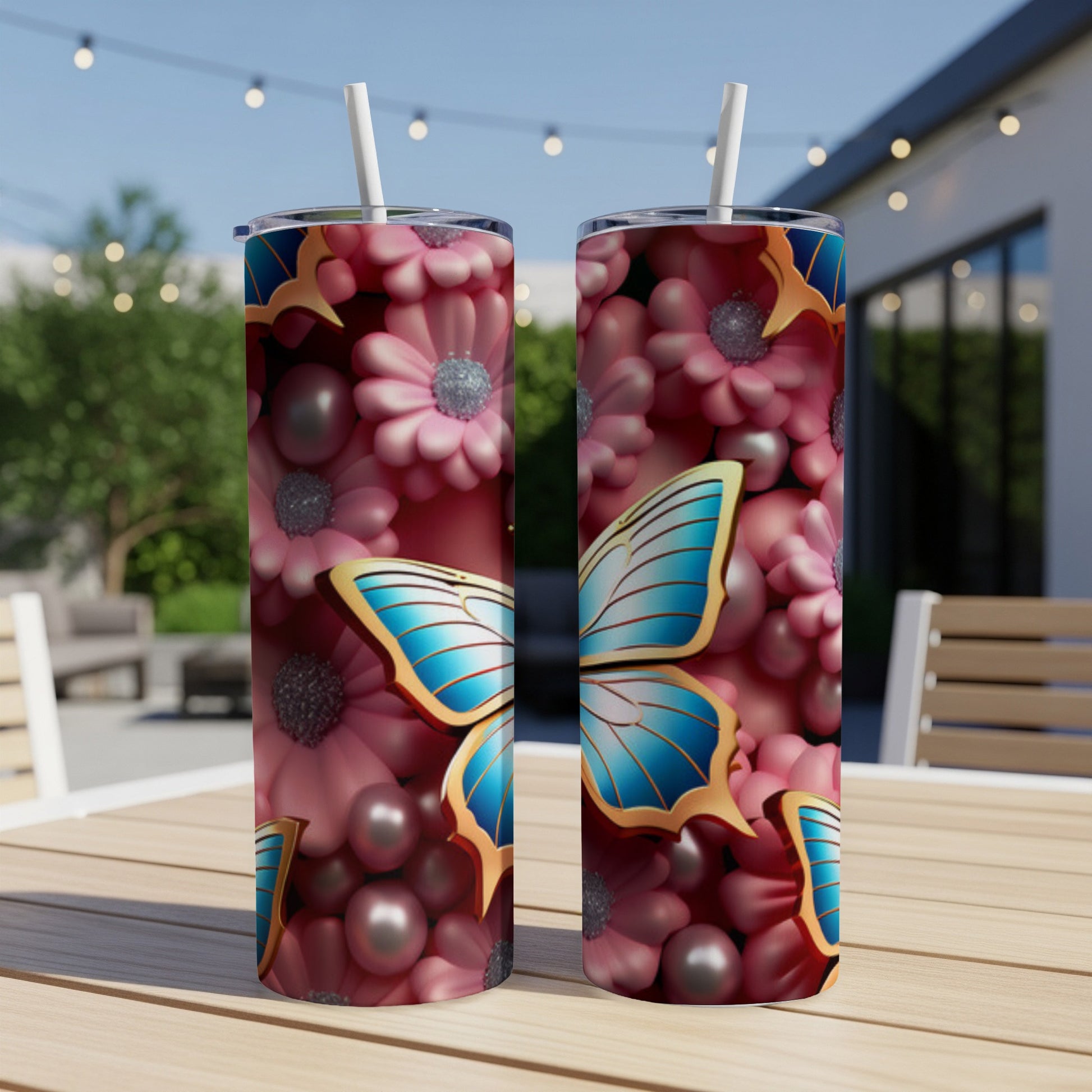 Two tumblers with a blue butterfly and pink floral design on a table.