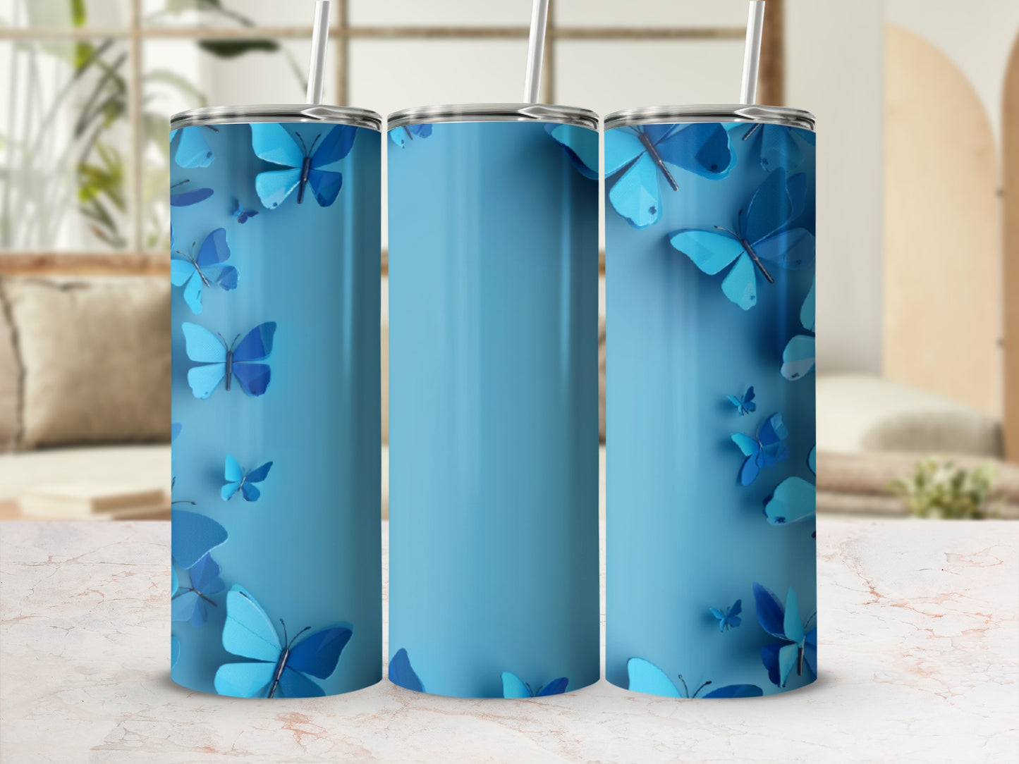 Blue tumbler with scattered butterfly graphics against a blurred background.
