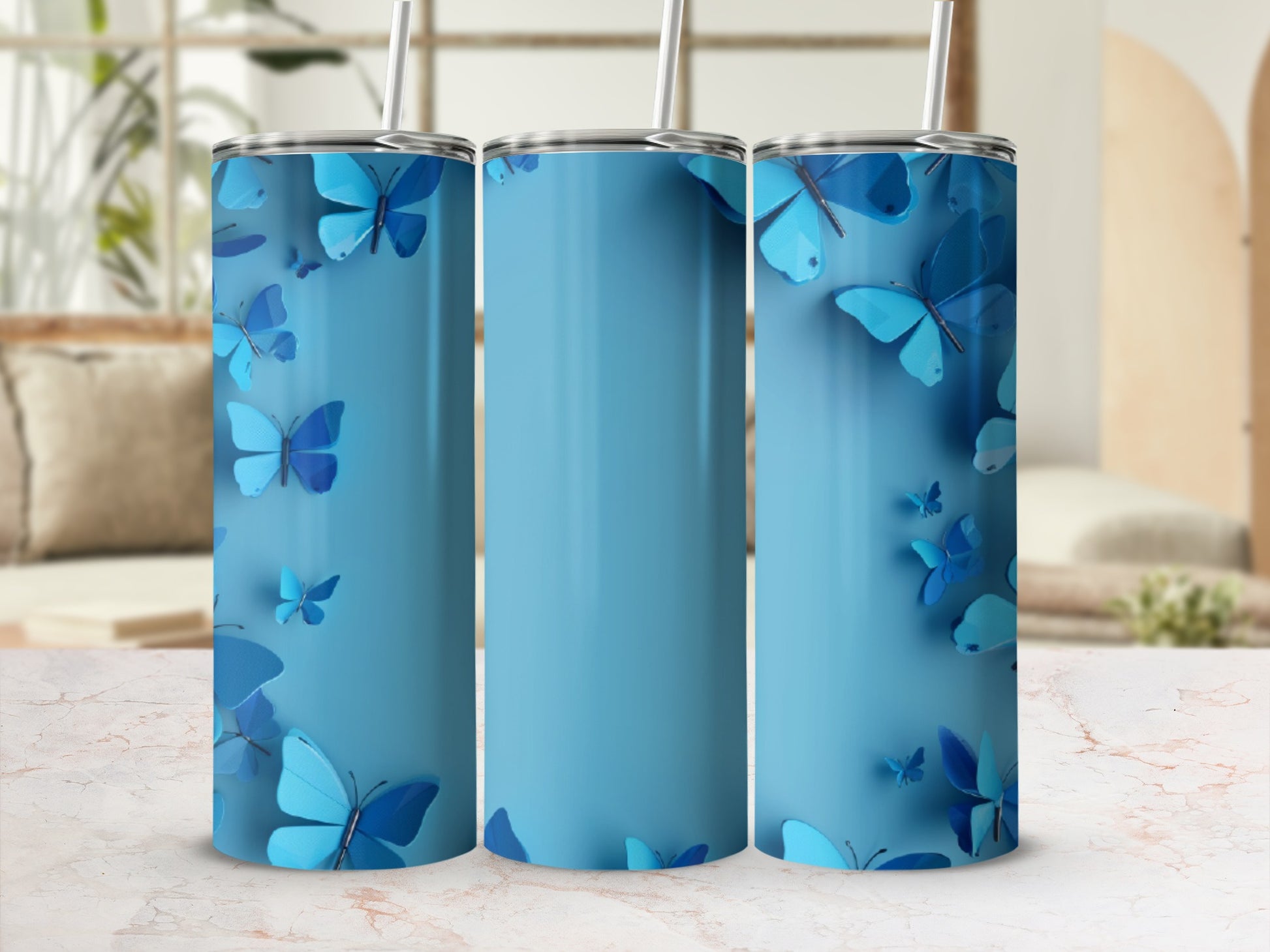 Blue tumbler with scattered butterfly graphics against a blurred background.