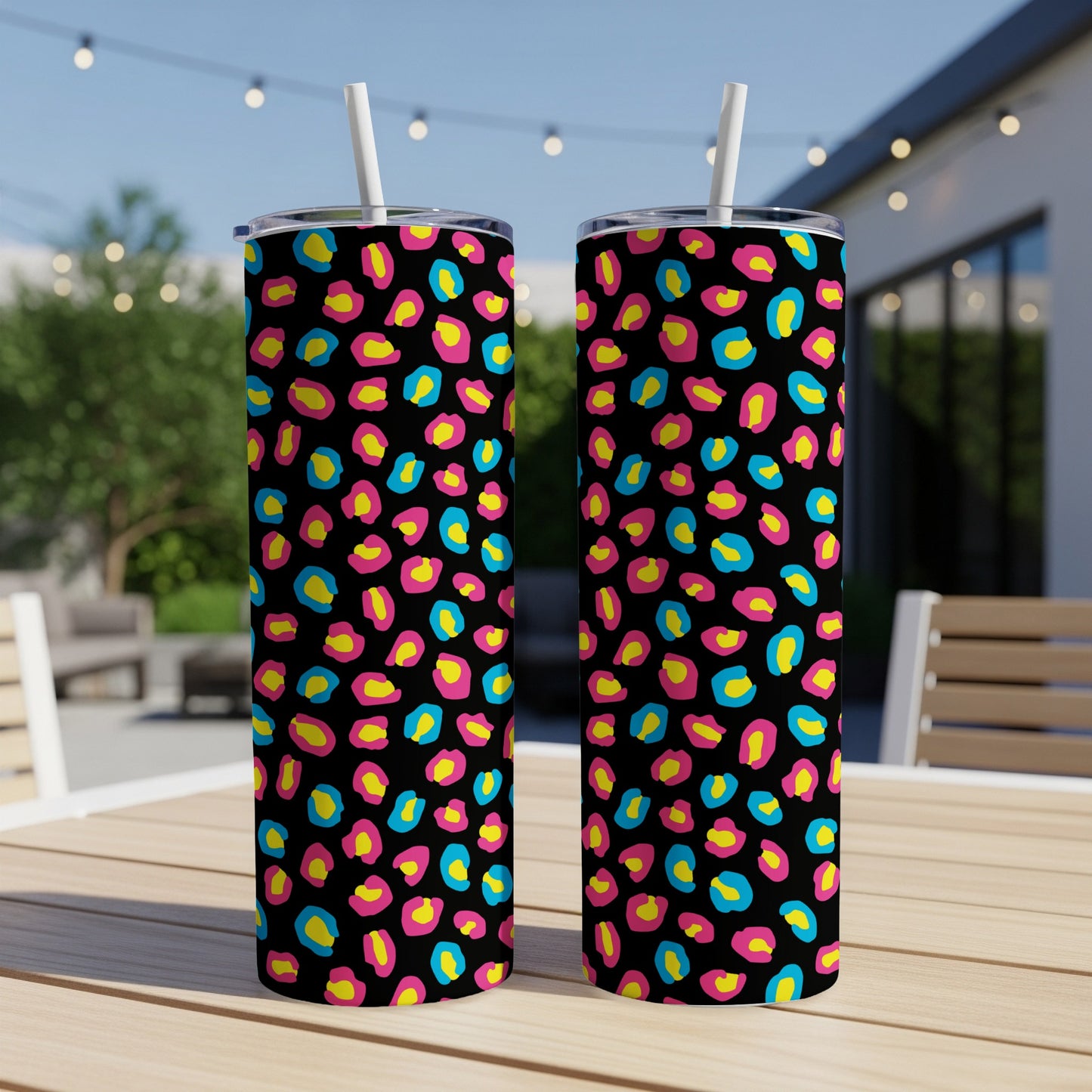 Two tumblers with a black background and brightly colored leopard print in hot pink, yellow, and teal.