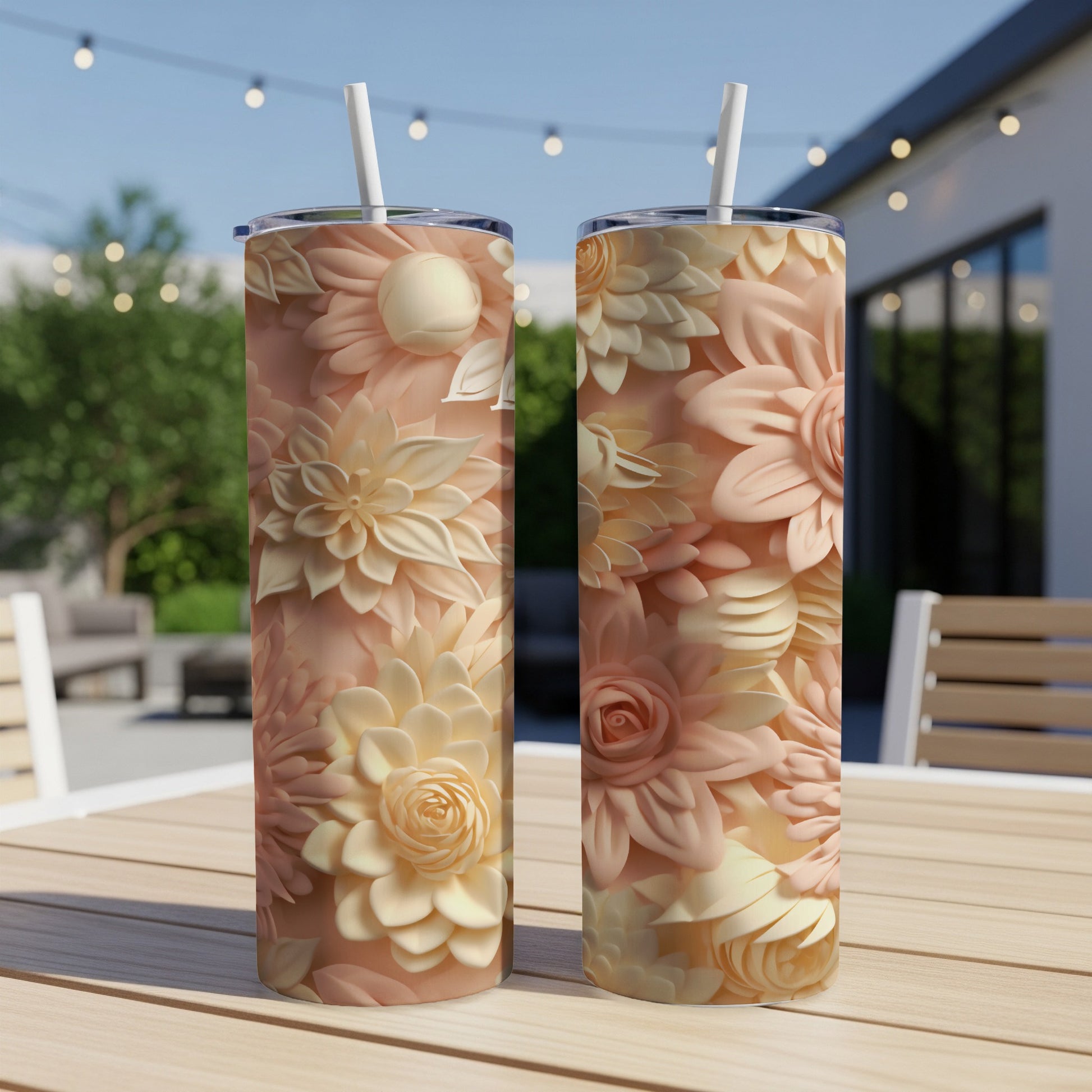 Two tumblers with floral patterns on a wooden table.