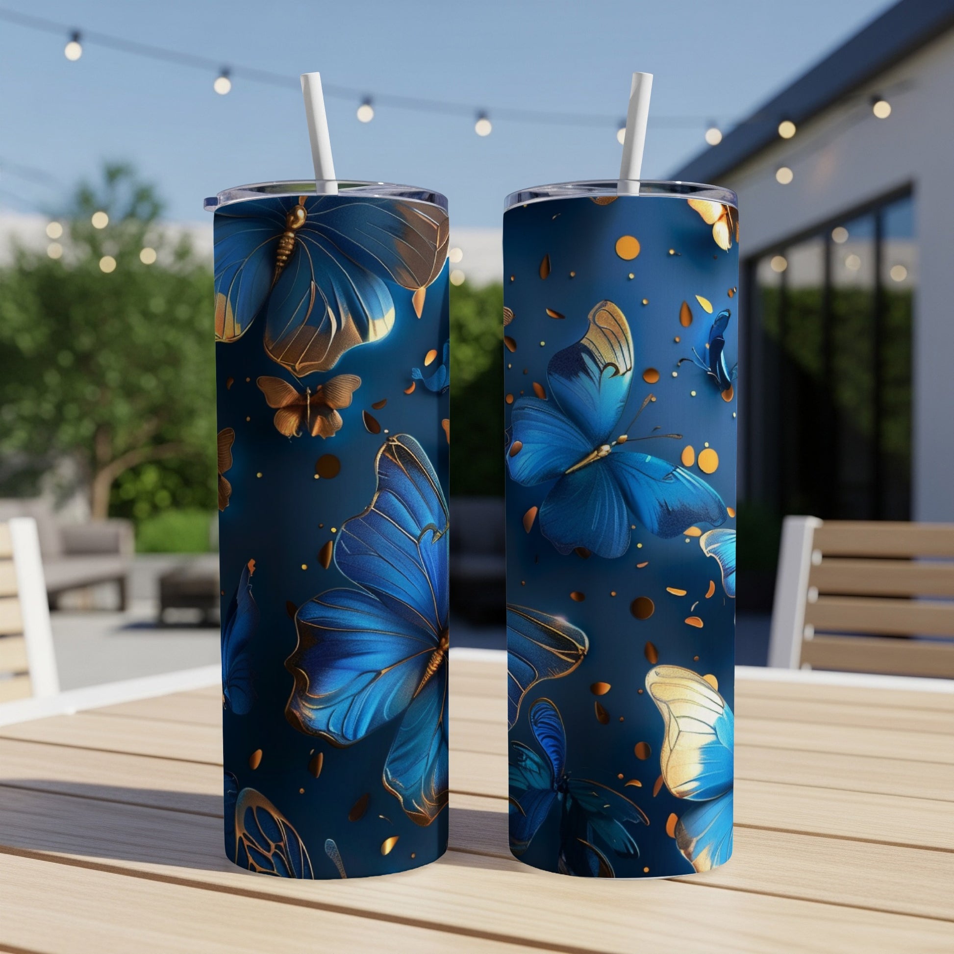 Two dark blue tumblers with gold and blue butterflies and polka dots.