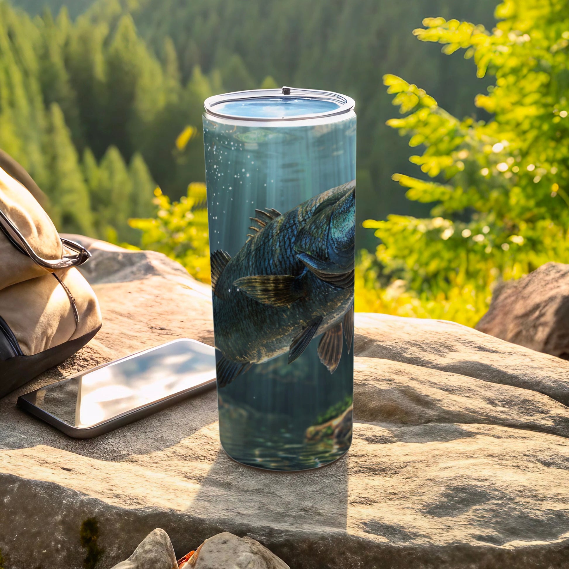 Large fish swims underwater on a tumbler next to a phone and backpack.