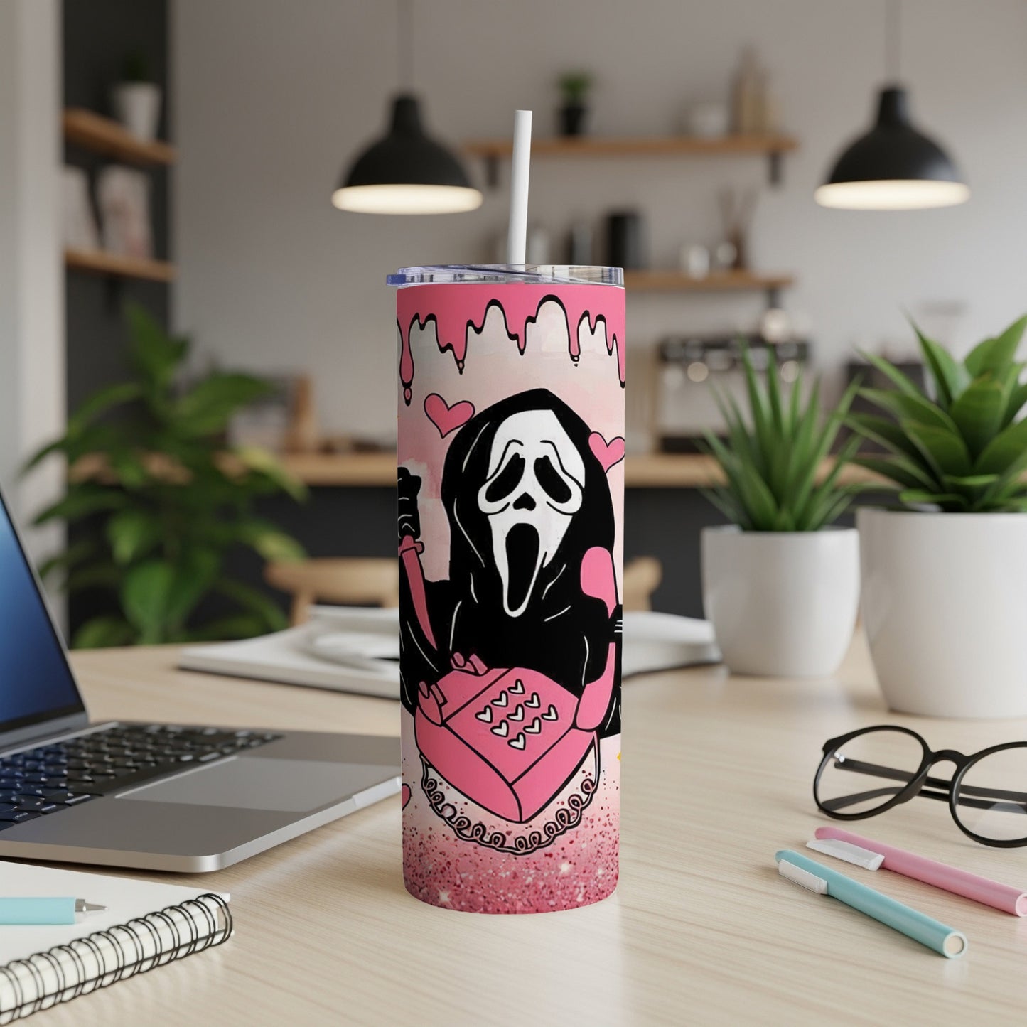Ghostface holding a pink glittery gift box, on a pink marble tumbler.