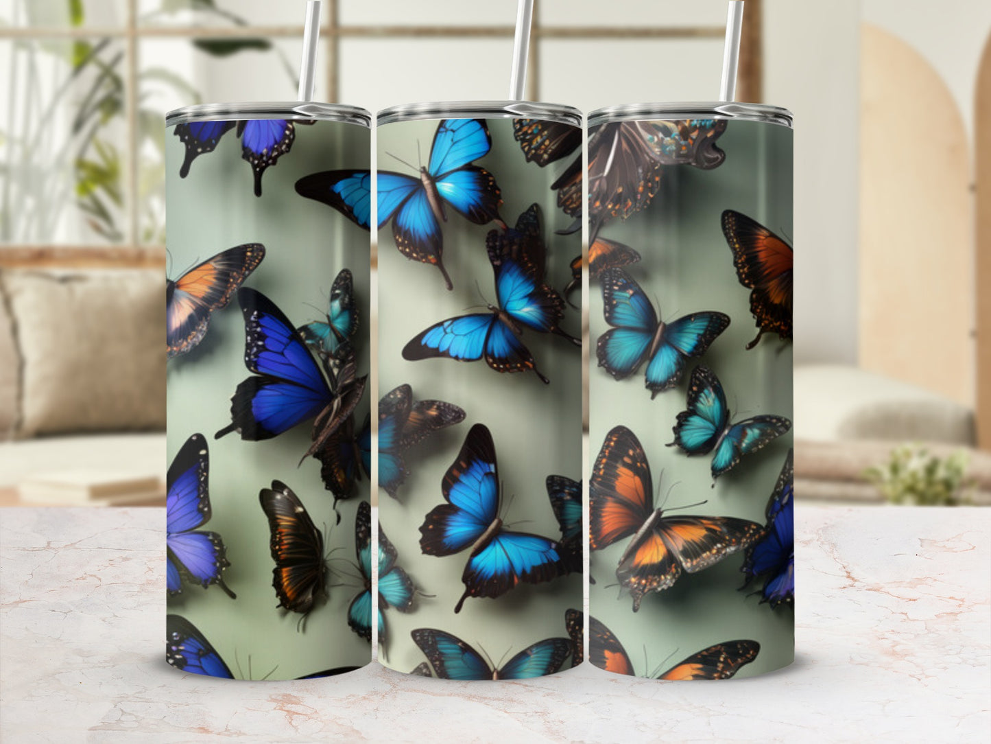Tumbler with blue and orange butterflies, some with intricate patterns.