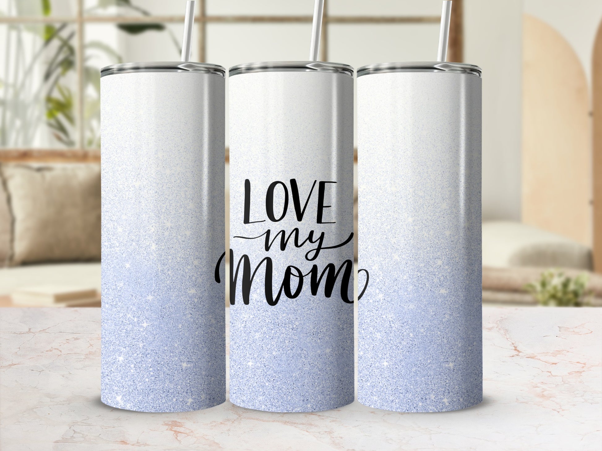 White and blue glitter tumbler with "Love Mom" text in black script.