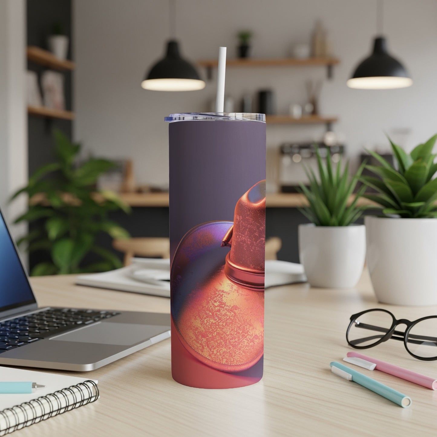 Tumbler with iridescent metallic lid and straw on a desk.