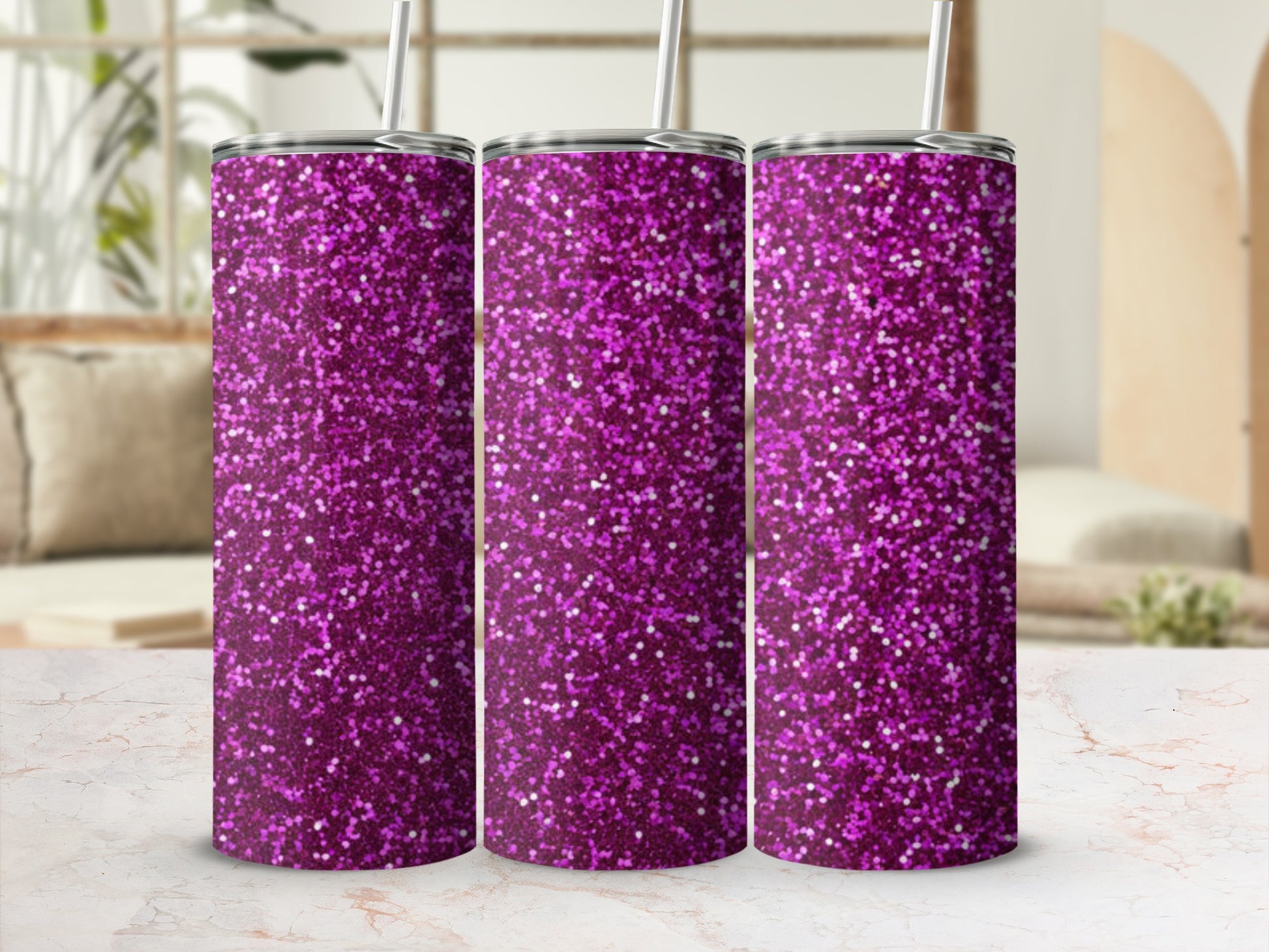 Three sparkly purple tumblers with straws on a marble surface.