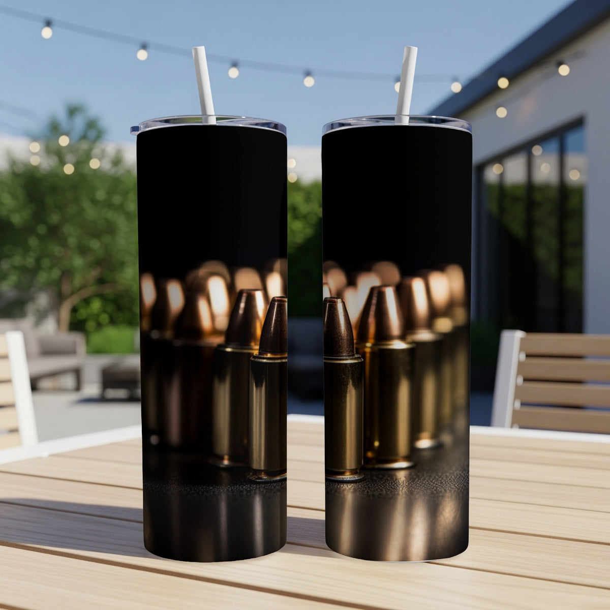 Two tumblers with a bullet pattern on a wooden table outdoors.
