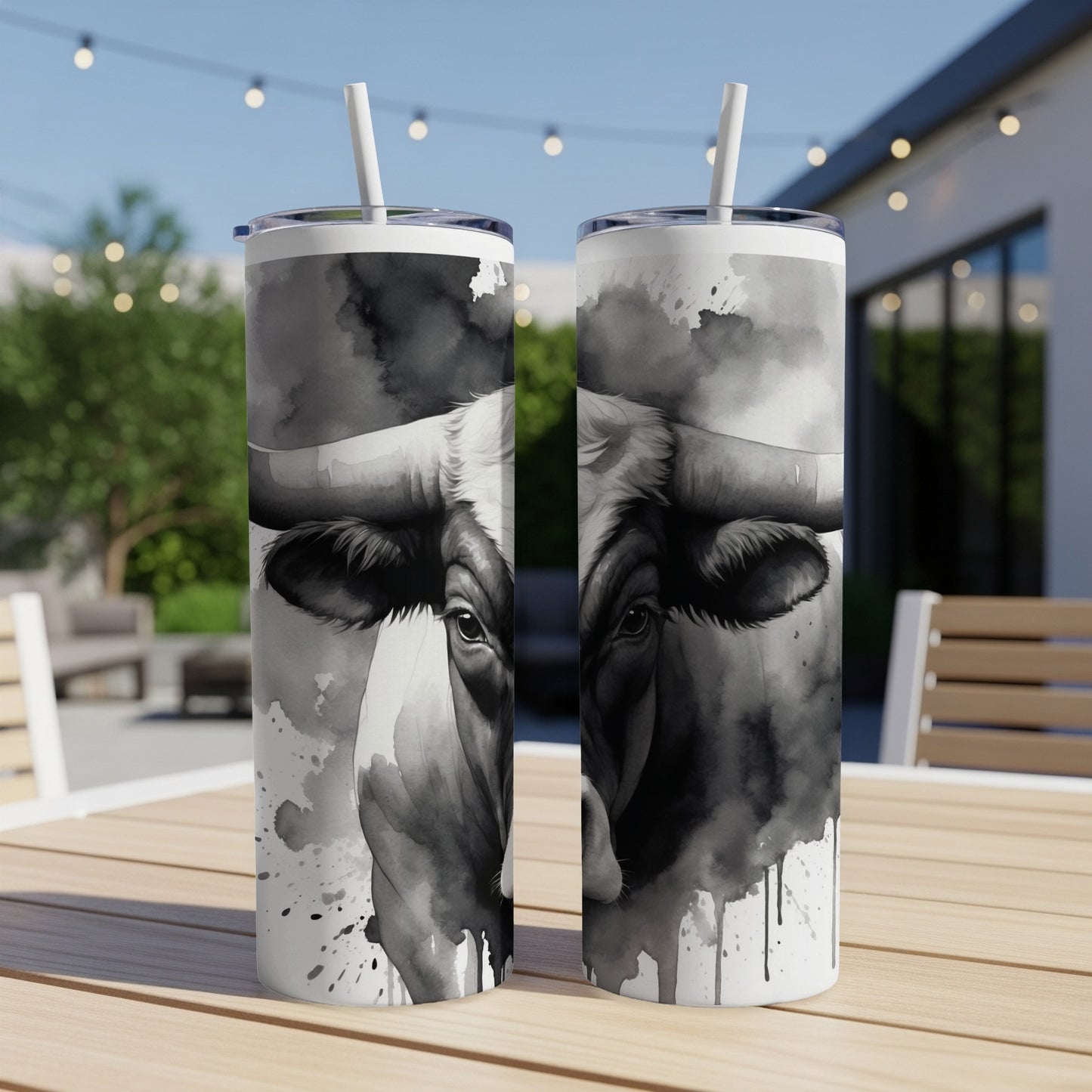 Black and white watercolor bull artwork on two tumblers.