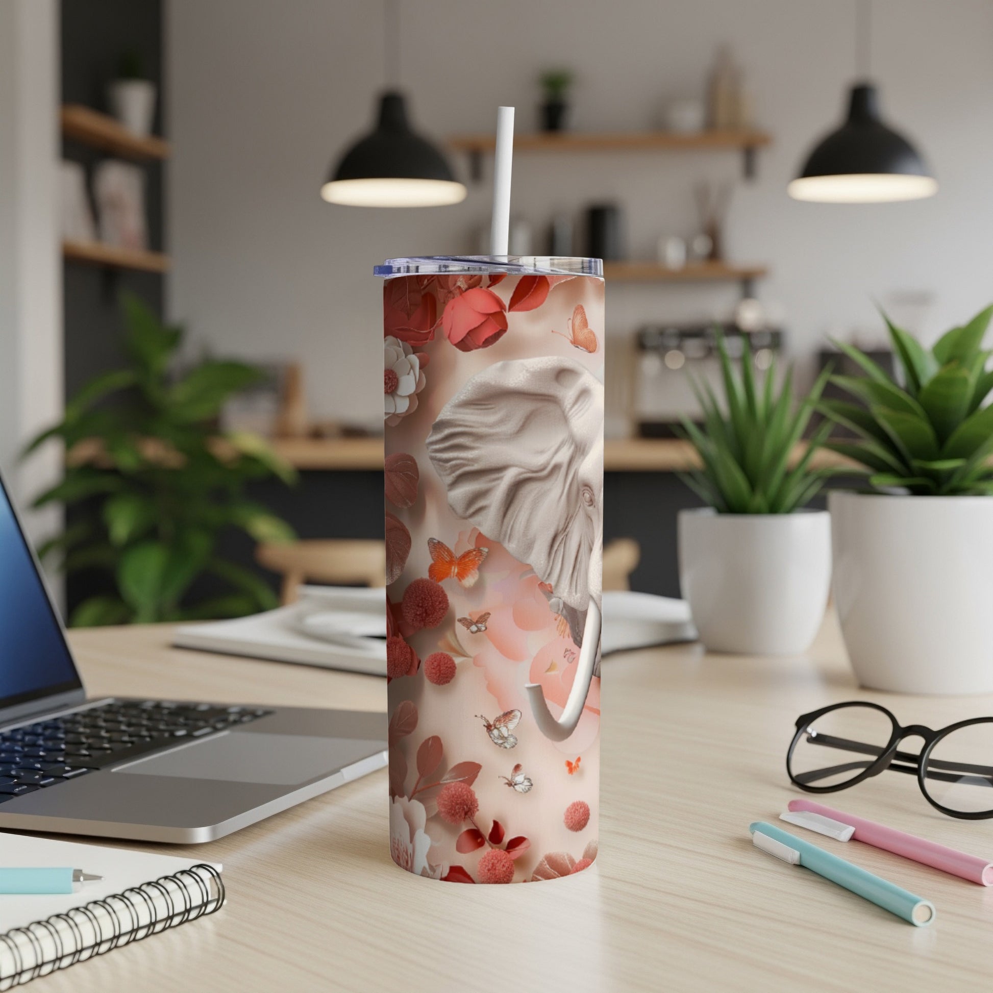 Tumbler with an elephant, flowers, and butterflies pattern.