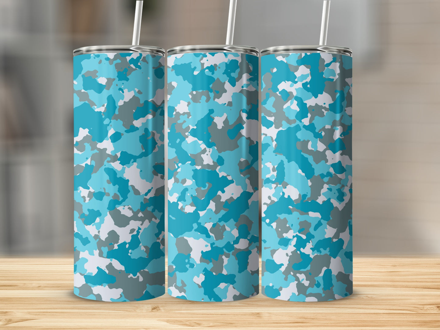 Three tall tumblers with a blue, gray, and white camouflage pattern, each with a straw.