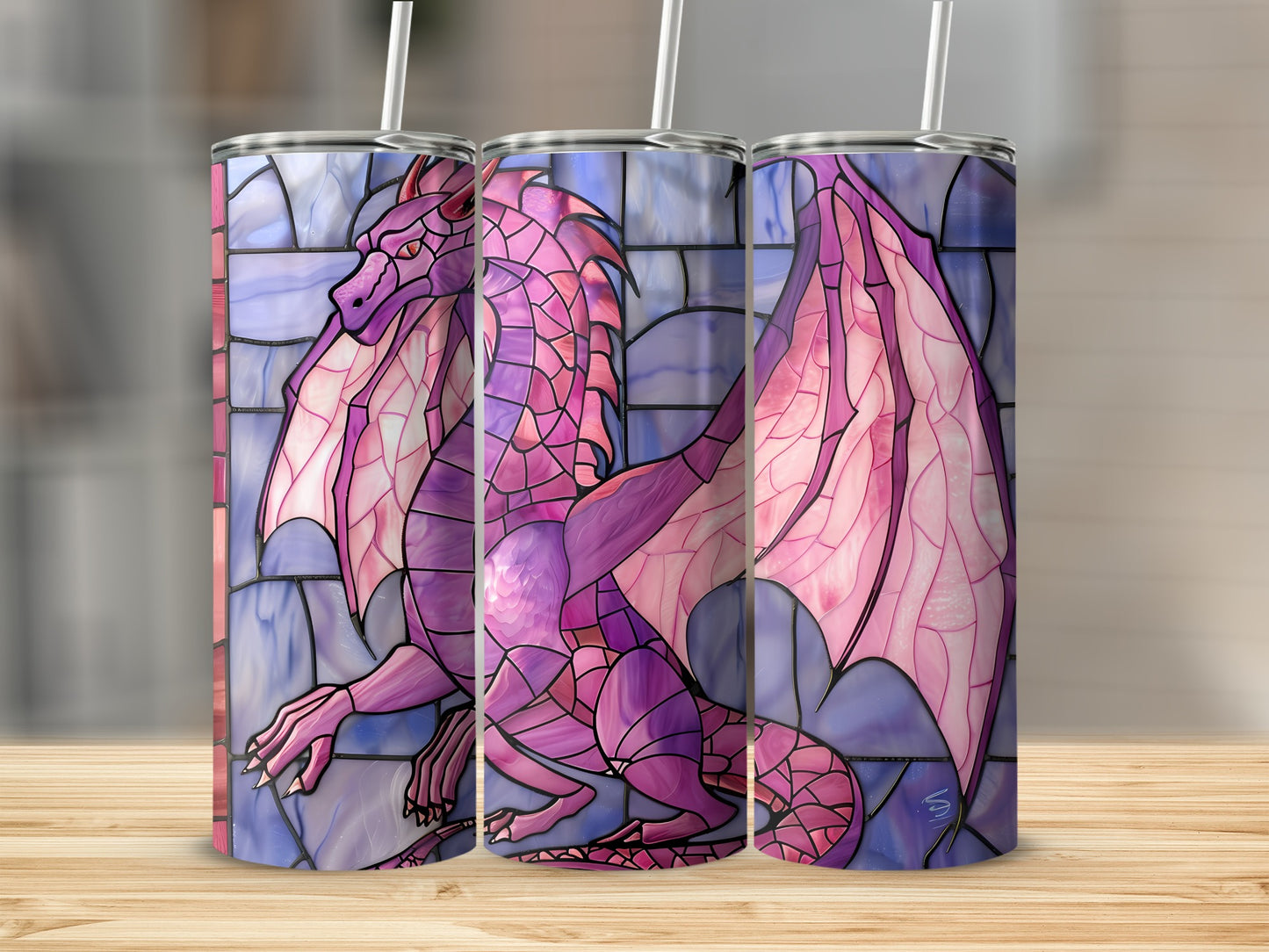 Pink stained glass dragon on a tumbler with a wooden background.