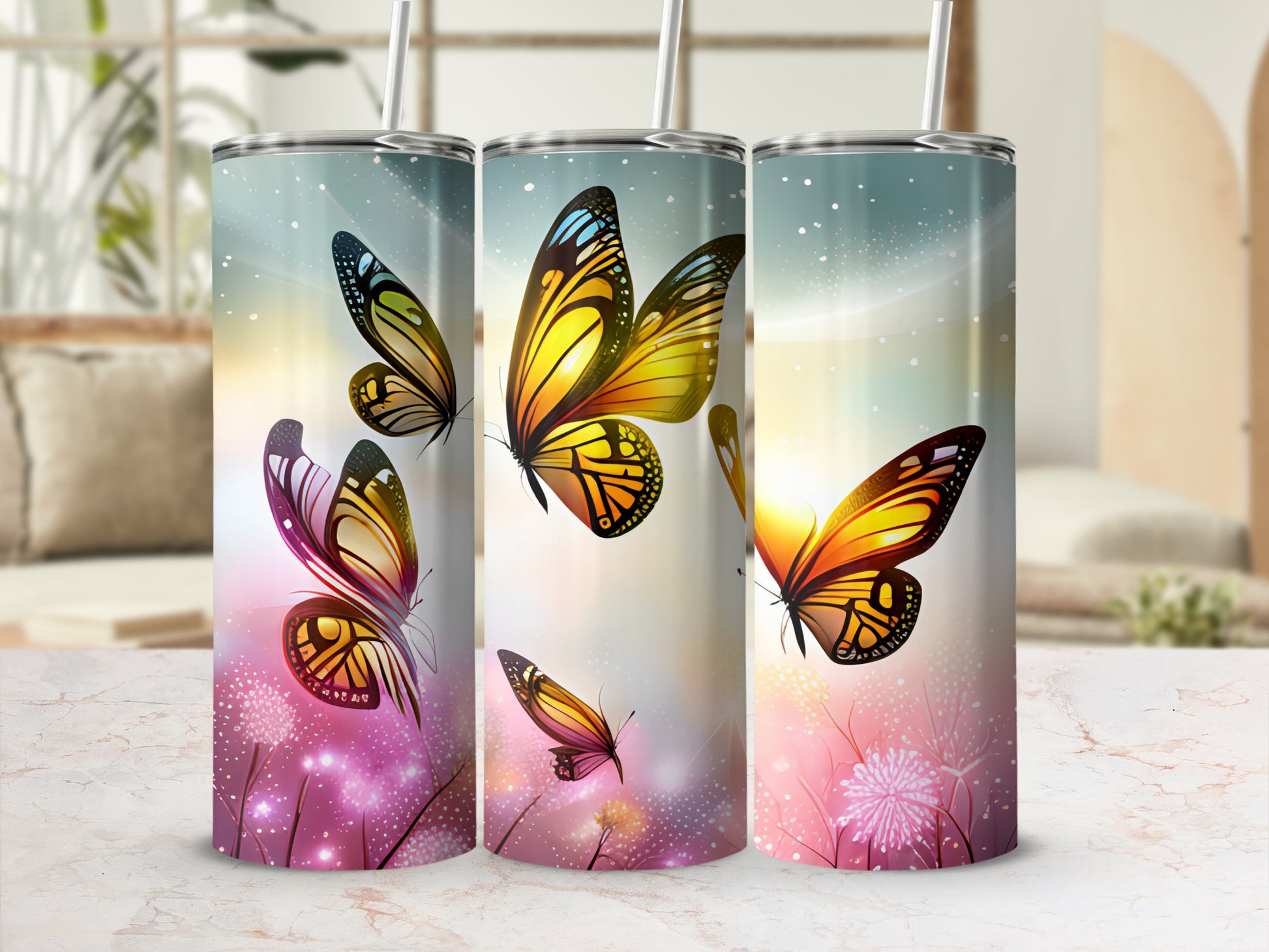 Three tumblers with colorful butterfly and floral designs.
