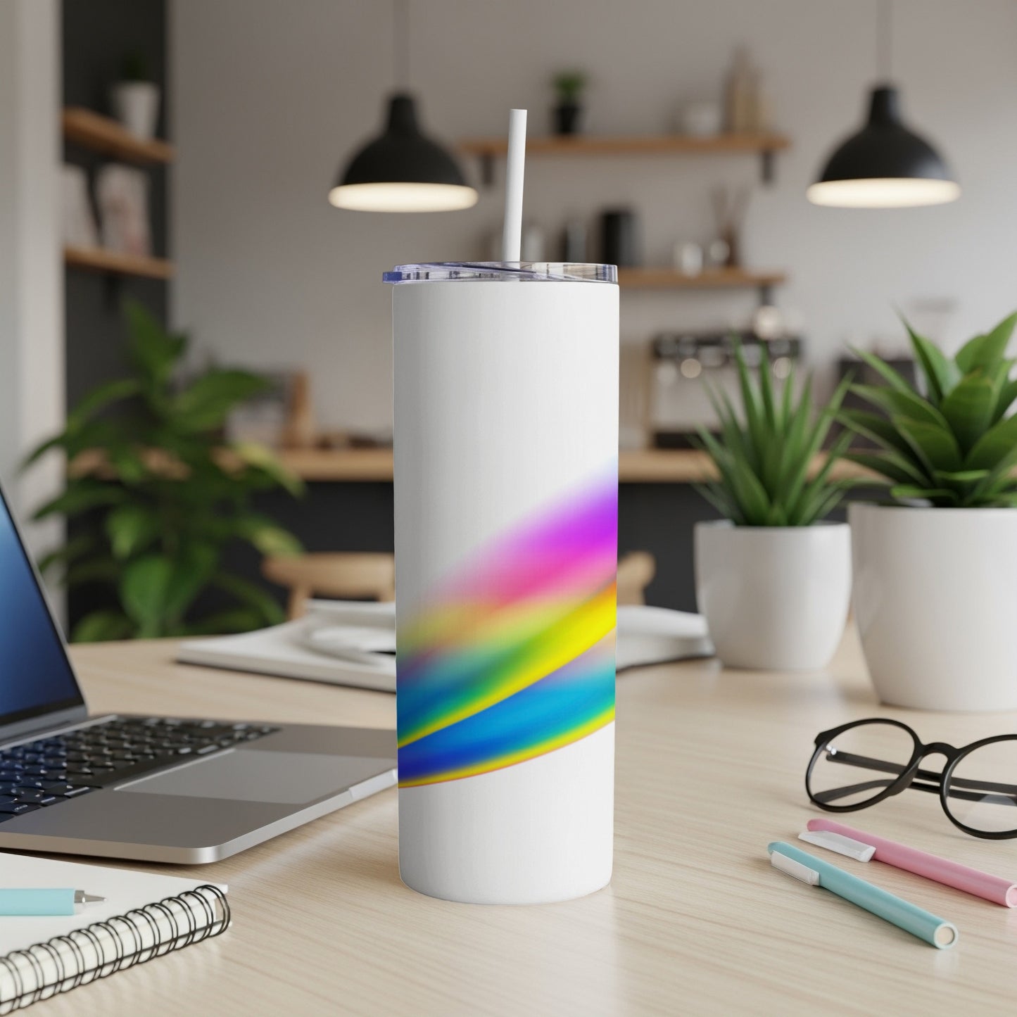 White tumbler with colorful abstract brush strokes and a straw.