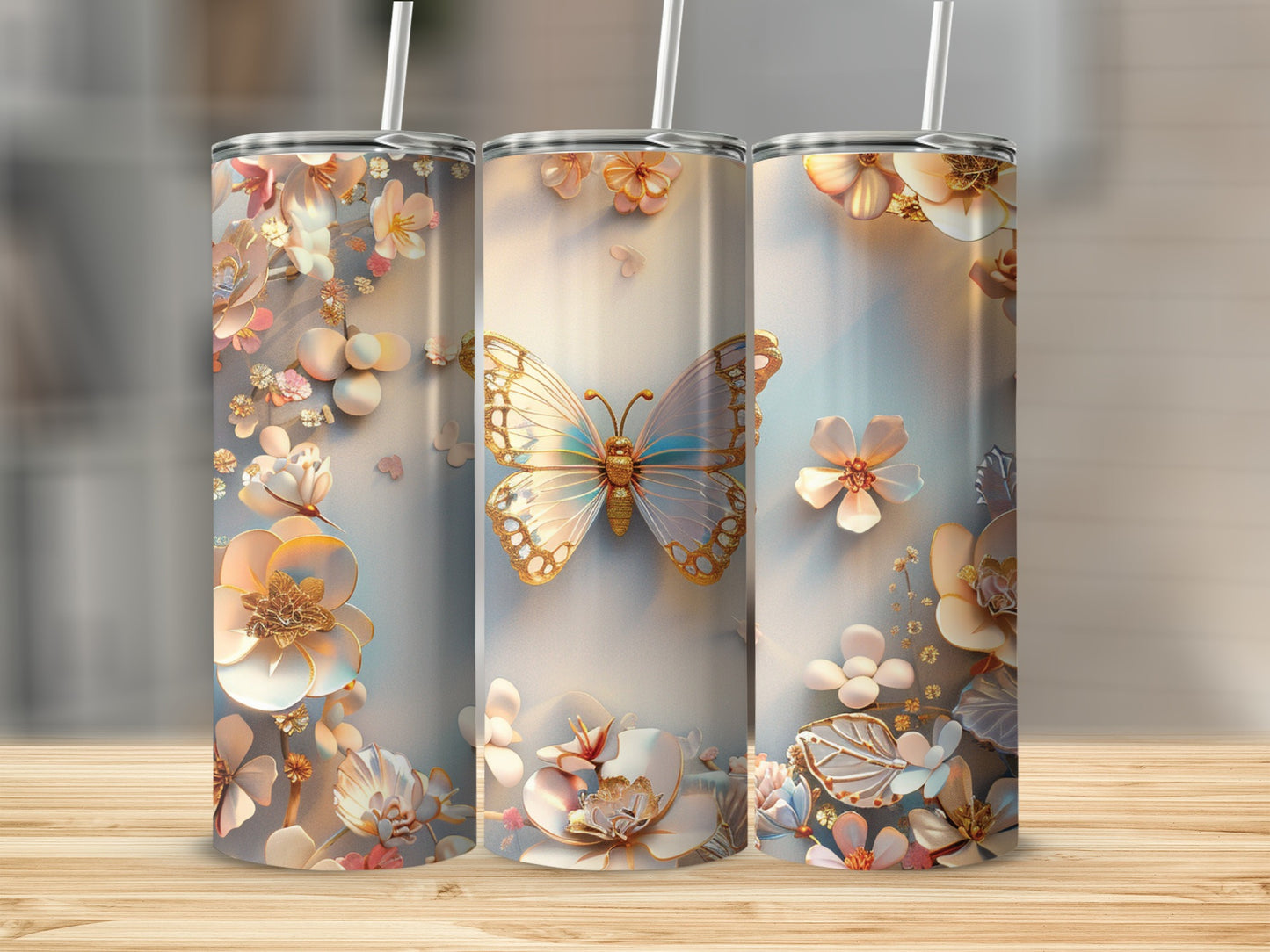 Three tumblers with a butterfly and floral design on a wooden surface.