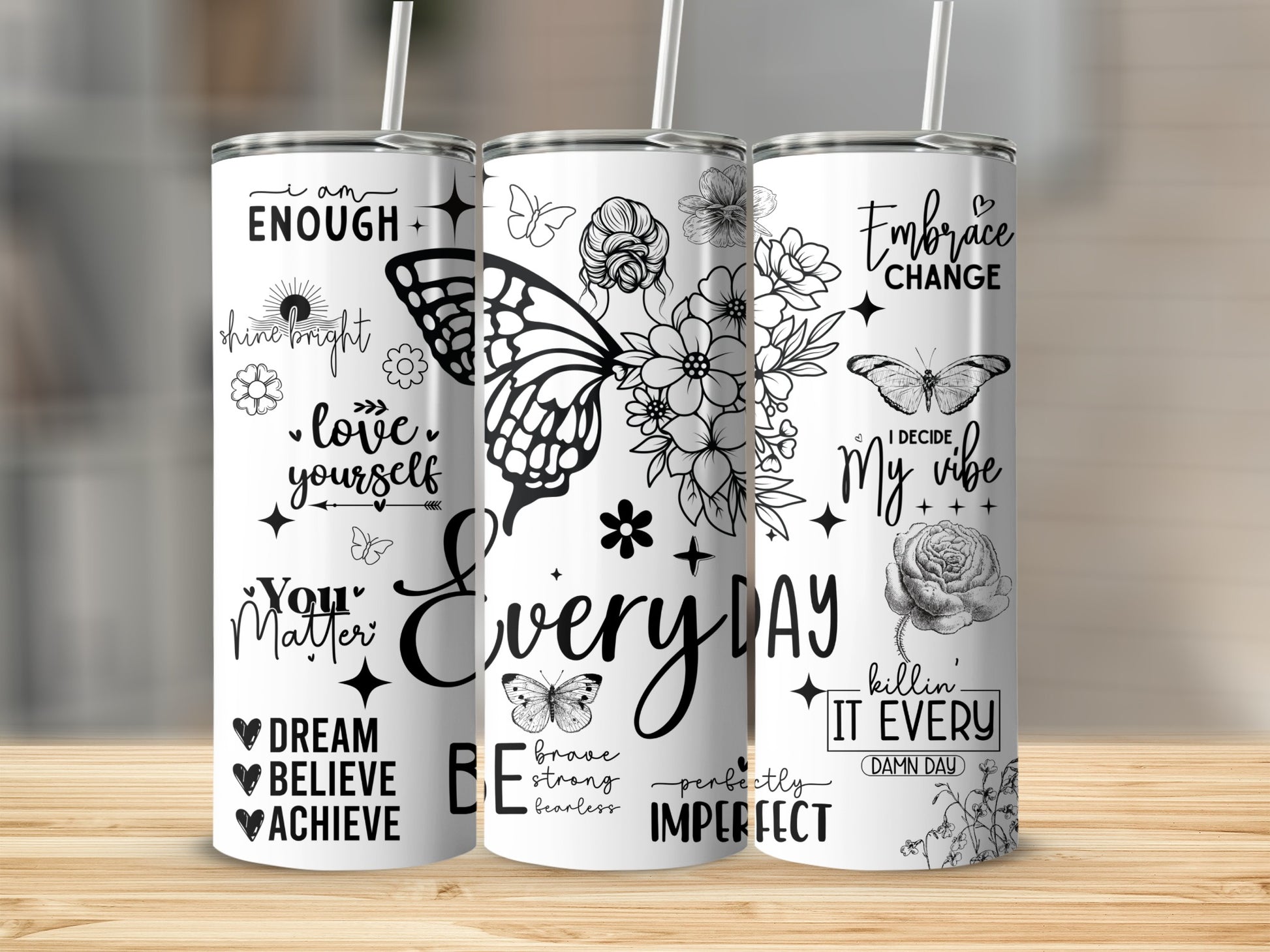 Tumbler with "I am Enough" and "Everyday" designs, featuring butterflies and floral elements.