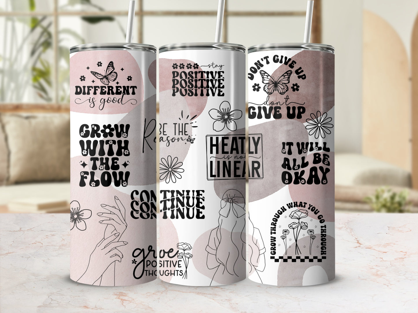 Floral and quote tumbler with motivational text and line art.