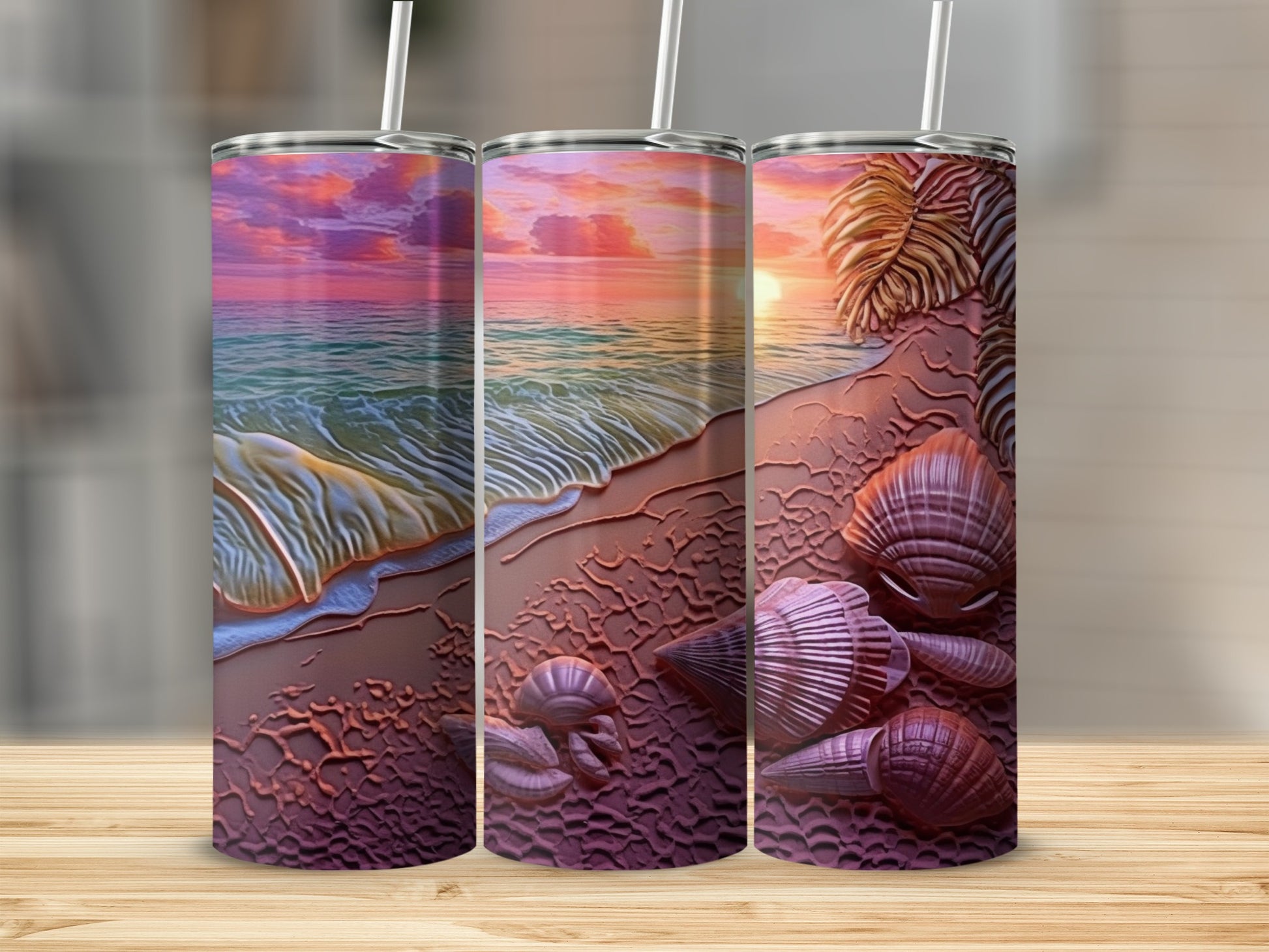 Beach scene with ocean waves, sand, shells, and palm frond on three tumblers.