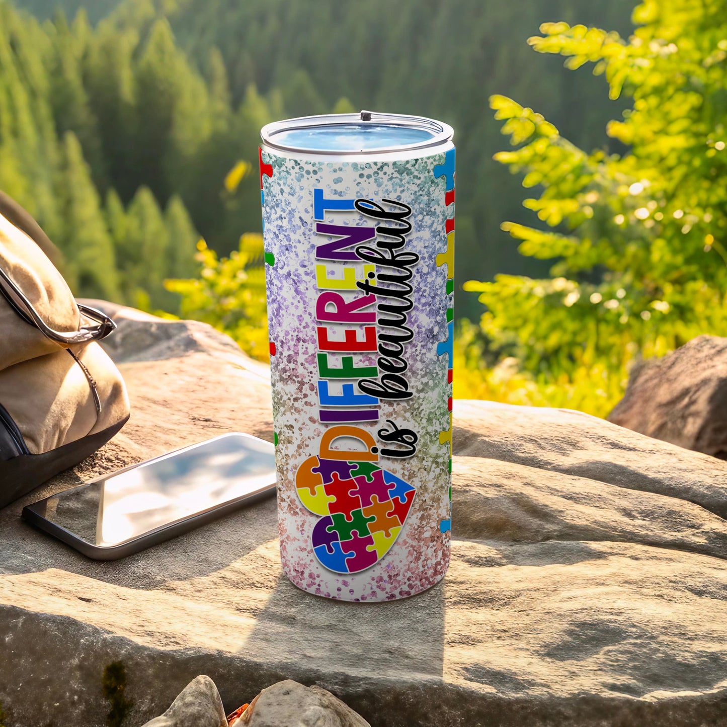 Autism awareness tumbler with colorful puzzle pieces and text "DIFFERENT is beautiful".