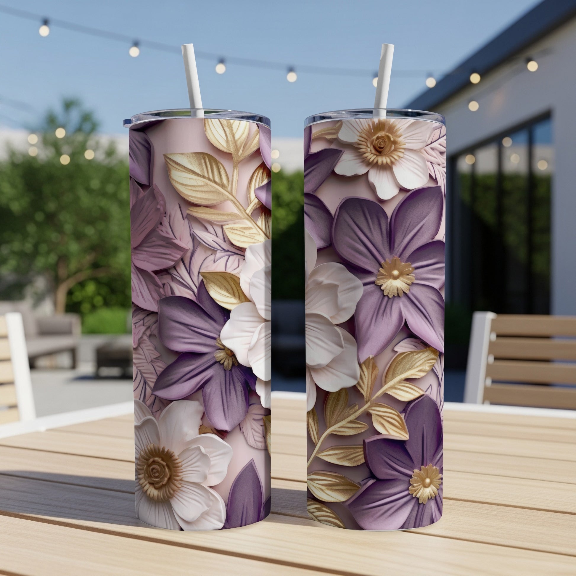 Two purple and white floral tumblers with gold leaves on a wooden table.