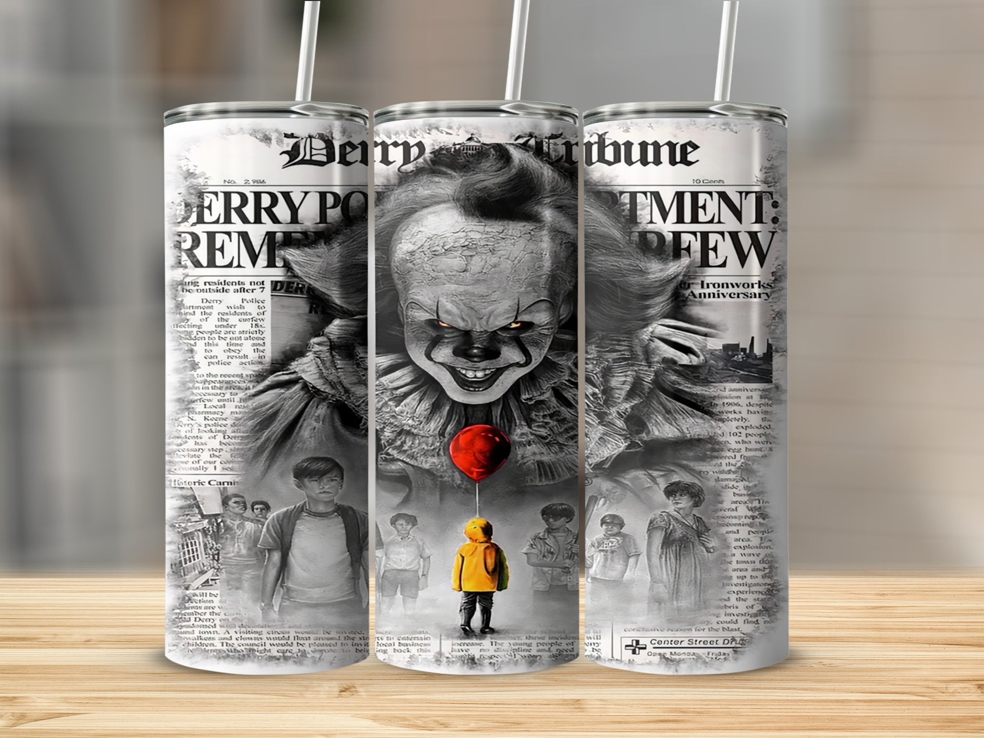 Pennywise and children on a newspaper print tumbler with Derry Tribune headlines.
