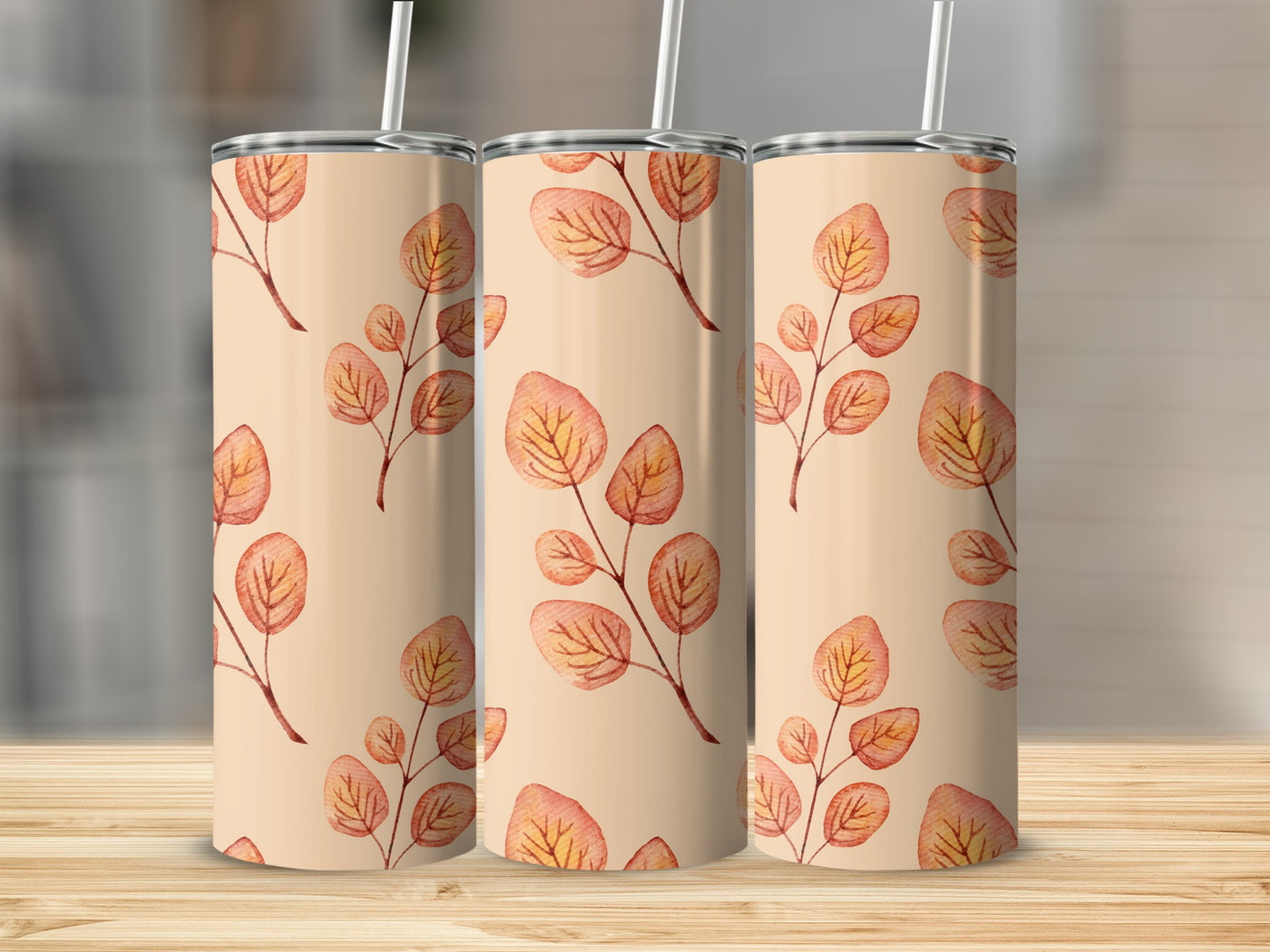 Three tumblers with a light brown background and a repeating pattern of autumnal leaves on branches.