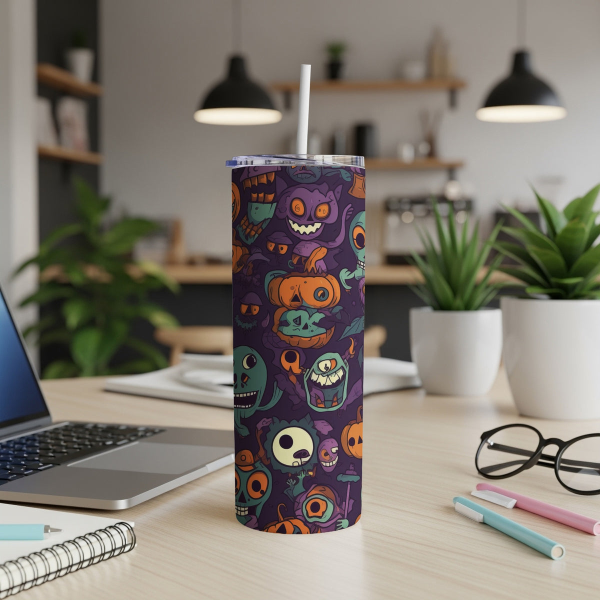 Tumbler with purple background featuring a collage of cartoonish Halloween monsters and pumpkins.