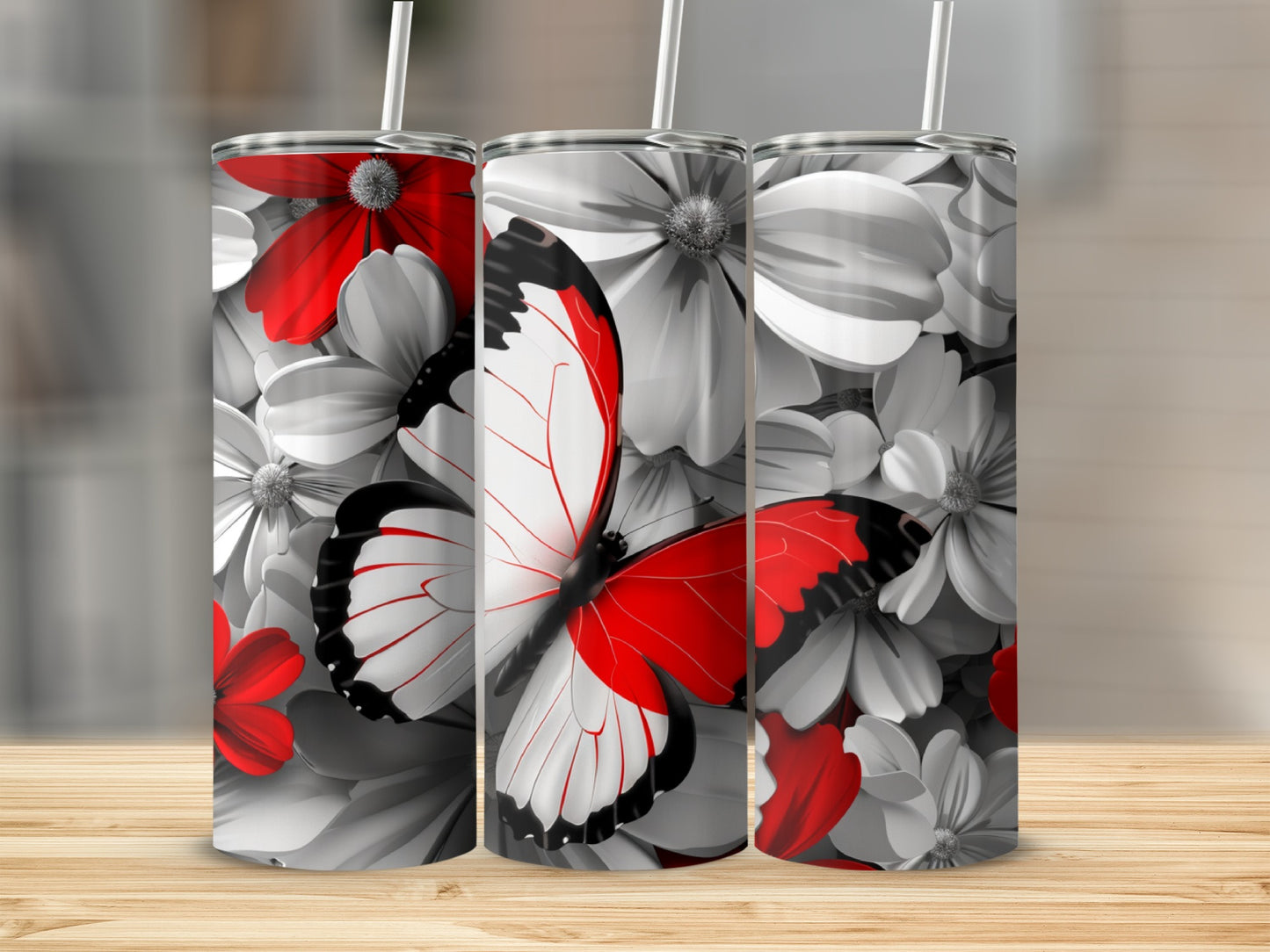 Three tumblers with a black, red, and white butterfly and floral design.