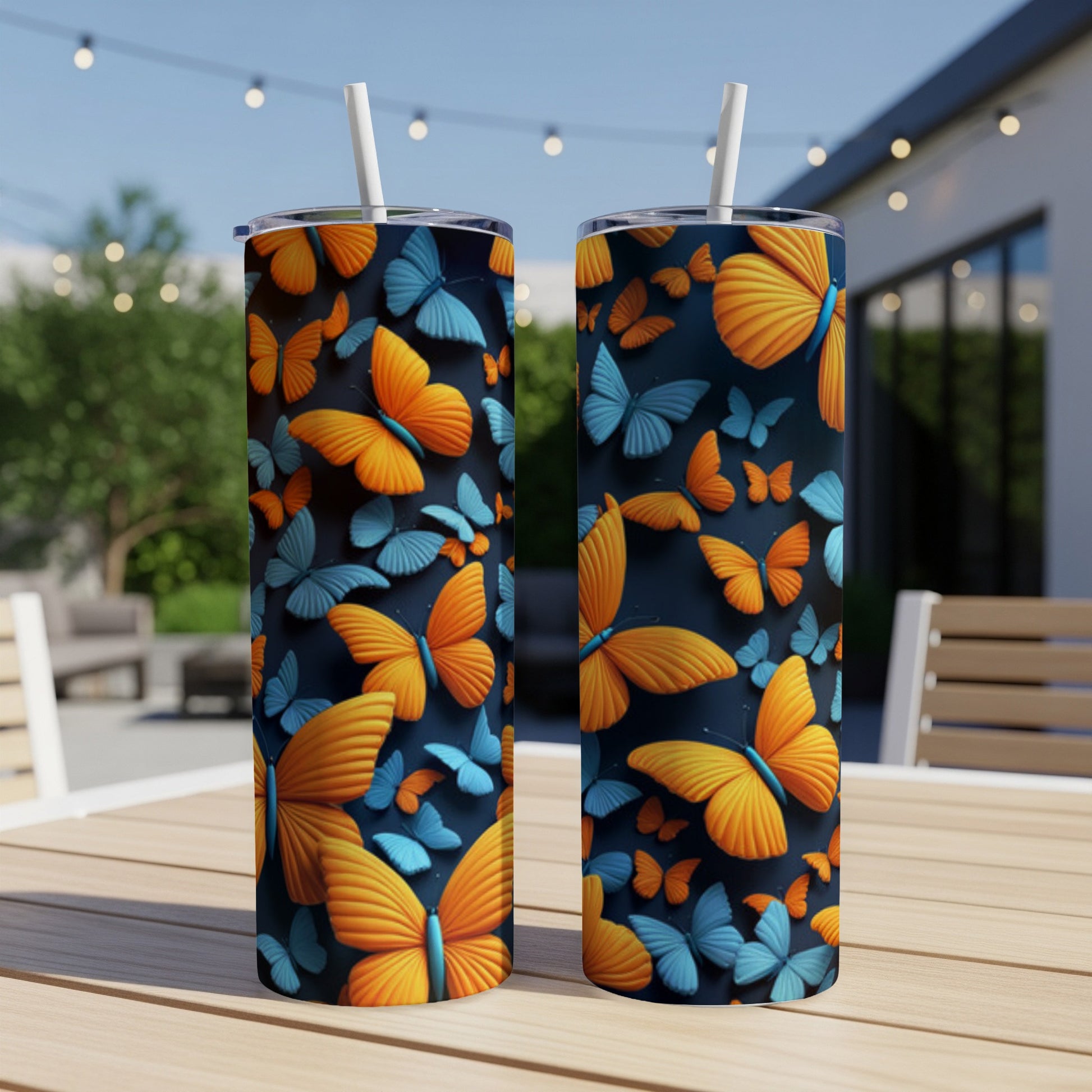 Two tall tumblers with an orange and blue butterfly pattern.