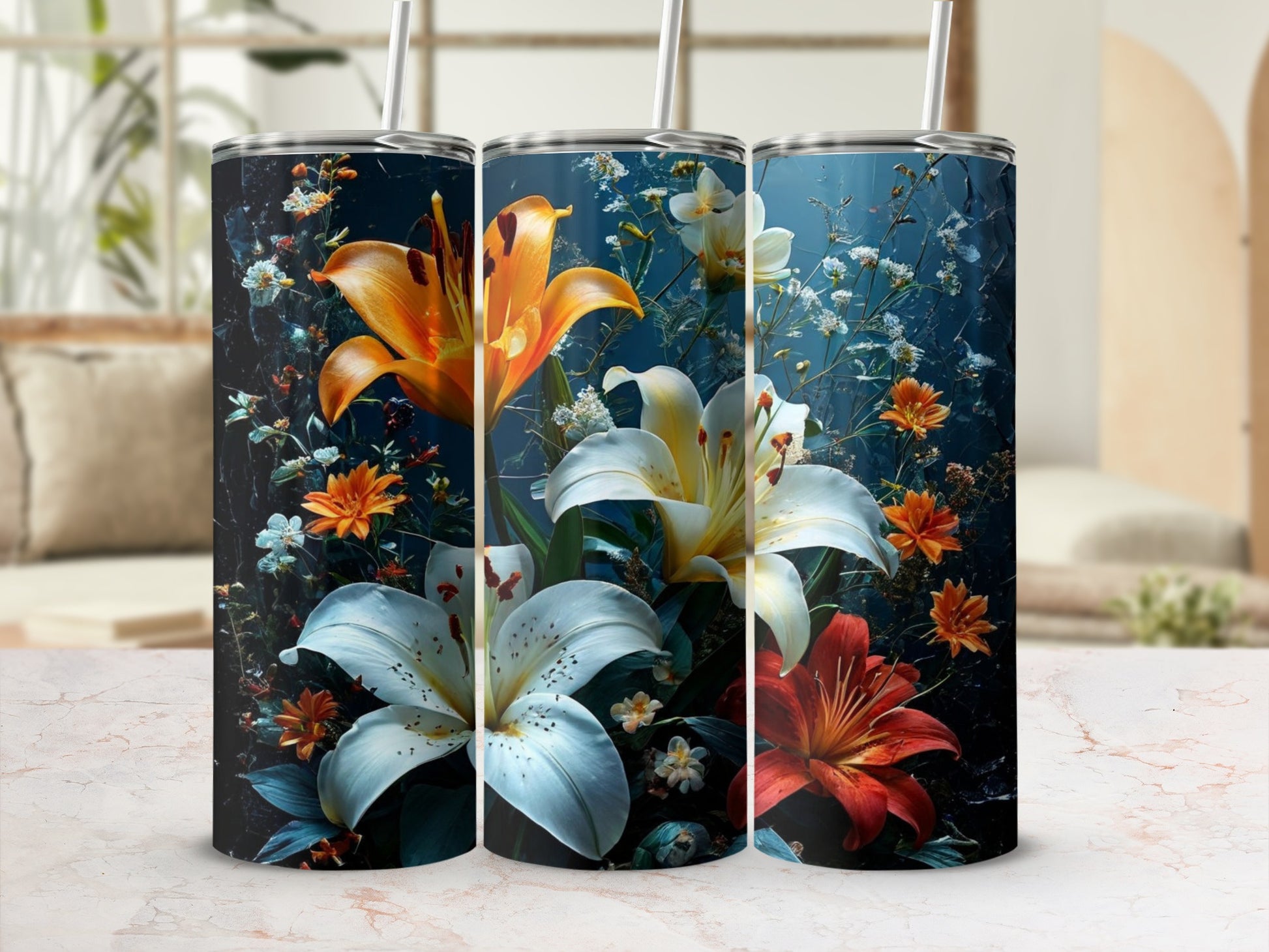 Three tumblers with realistic lily and floral designs against a blurred background.