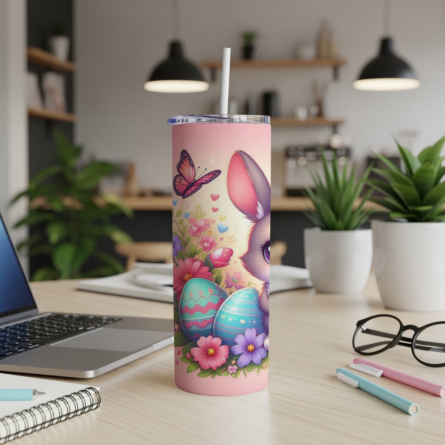 Pink tumbler with Easter bunny, eggs, and flowers, straw inserted.