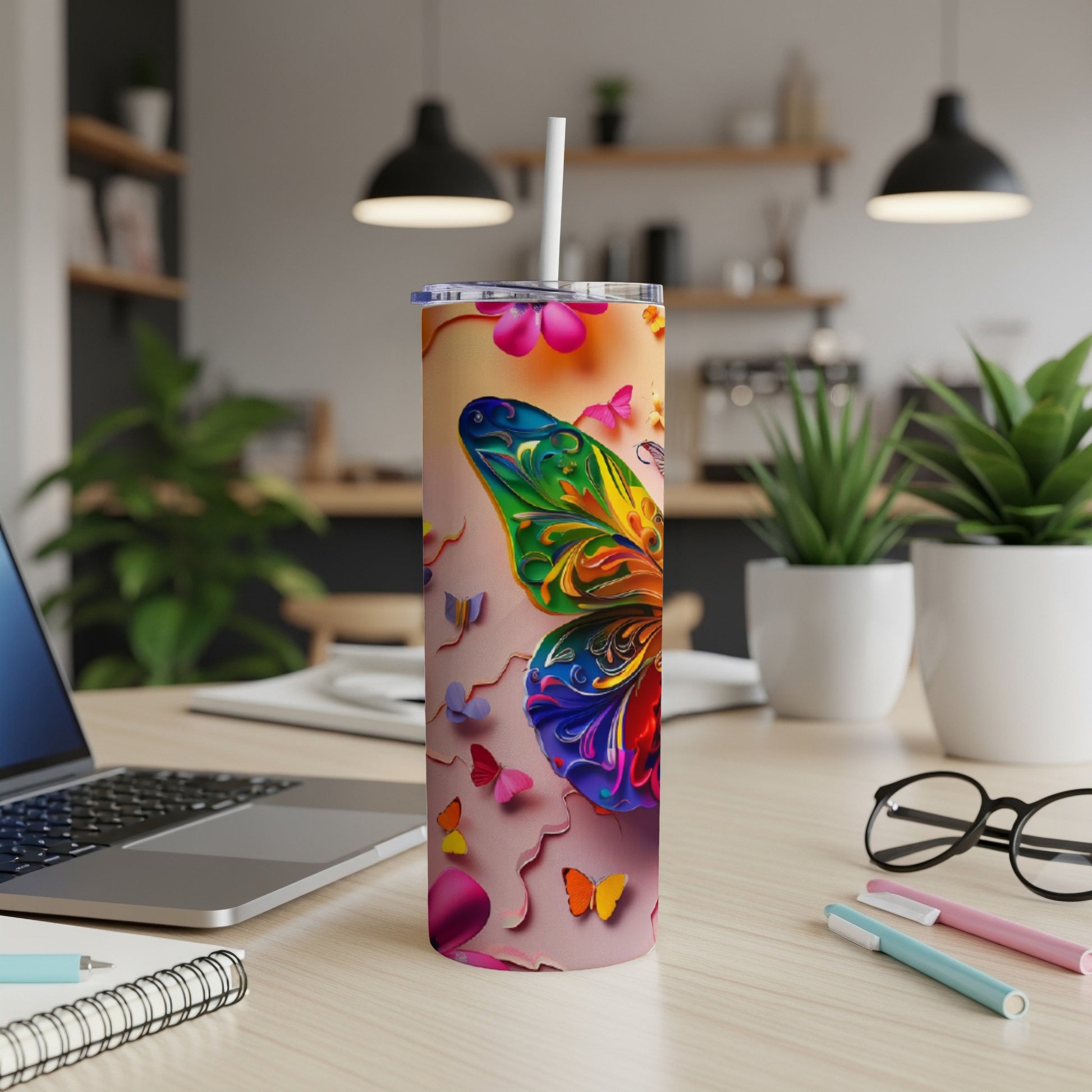 Colorful butterfly design on a stainless steel tumbler with a straw.