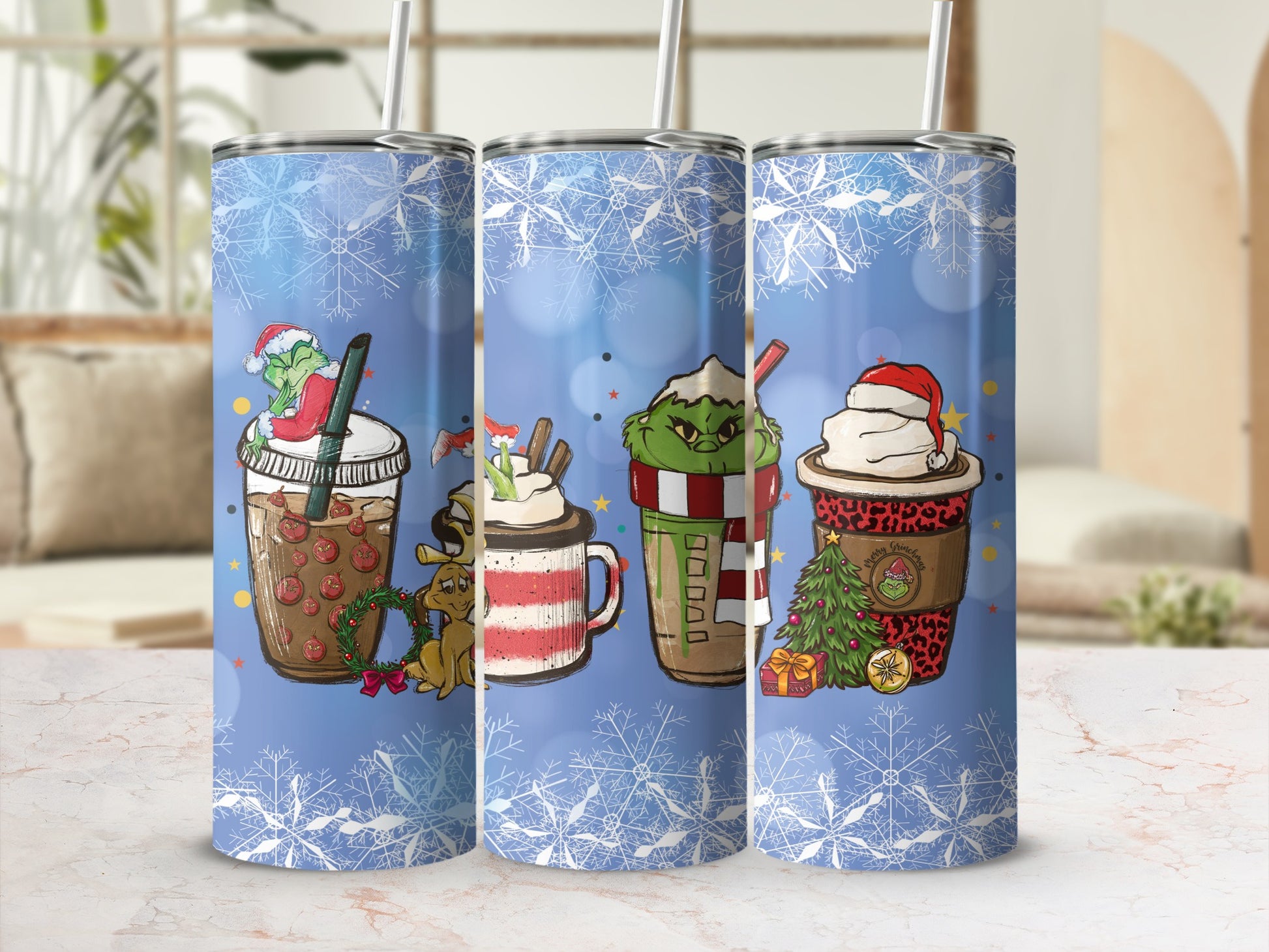 Three Grinch-themed insulated tumblers with holiday designs and snowflakes.