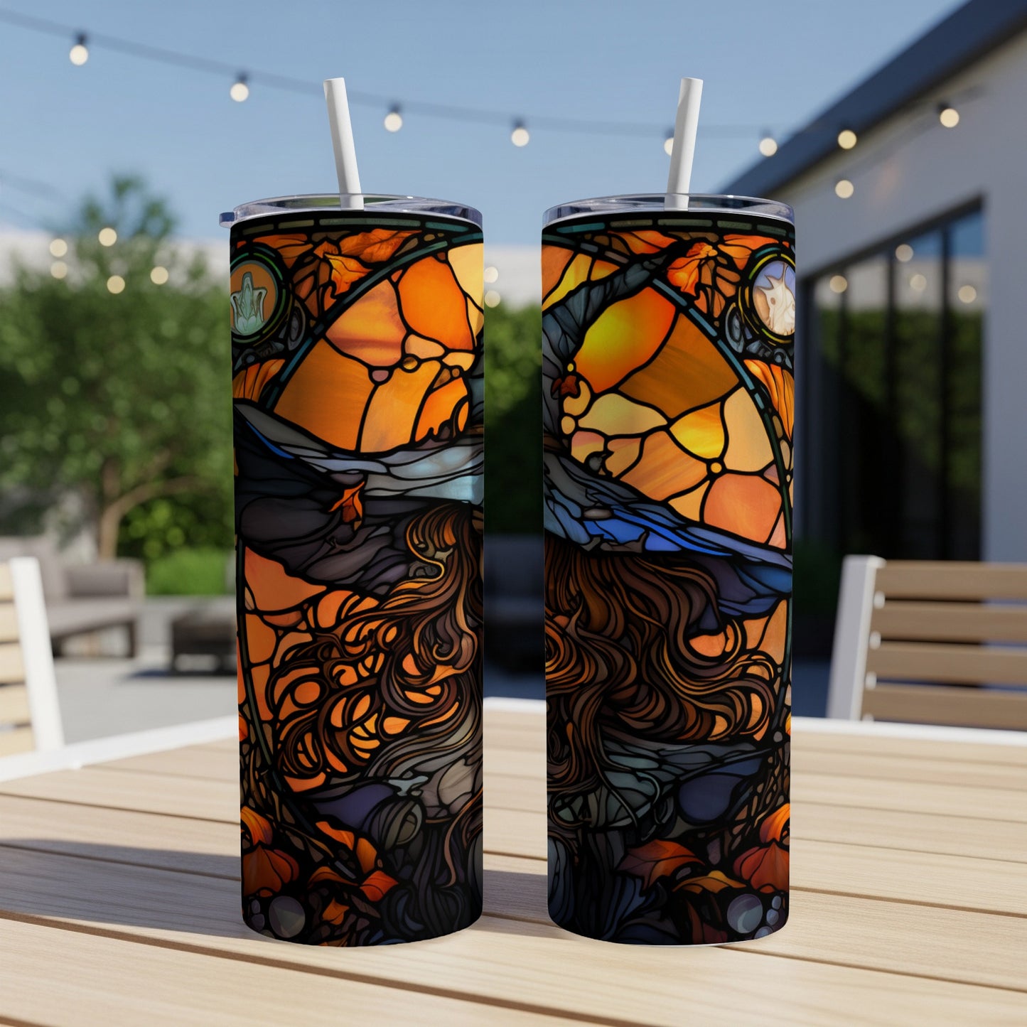 Two tumblers featuring a stained-glass style witch with orange and black hues.