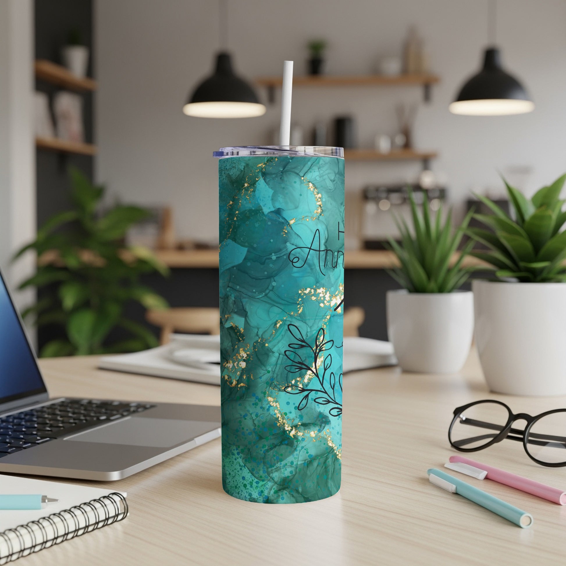Teal abstract tumbler with gold accents and floral design.