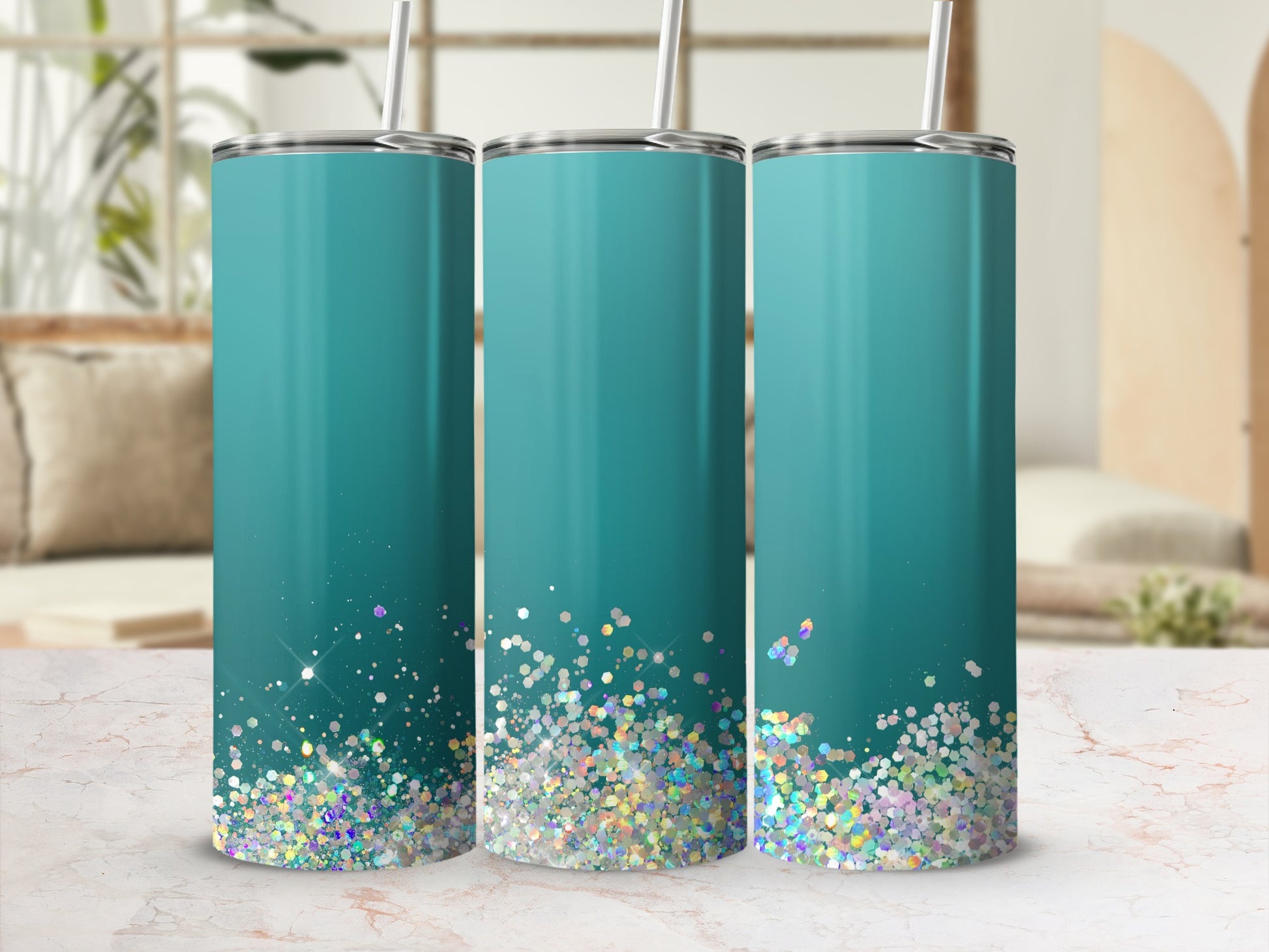 Three aqua tumblers with glitter accents and silver lids and straws.