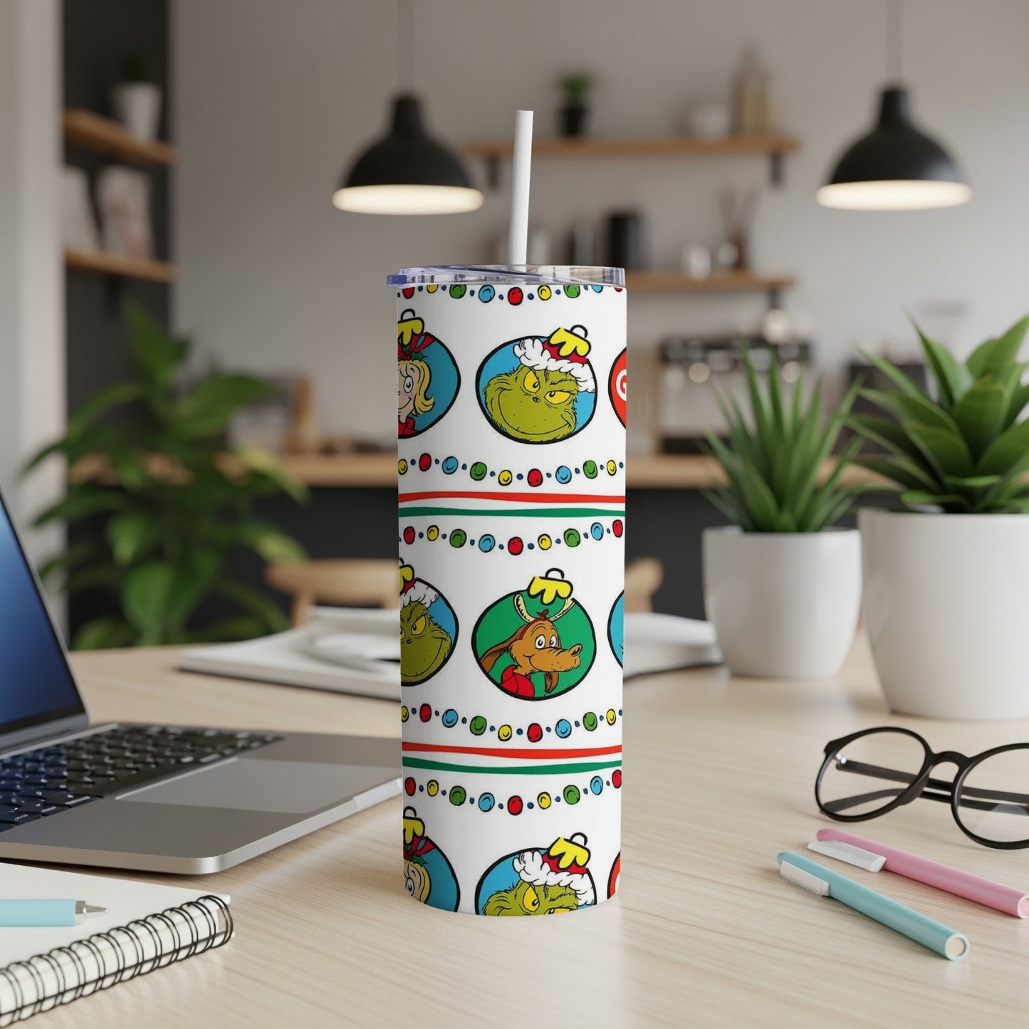 White tumbler with Grinch cartoon faces and holiday patterns.